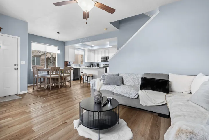 Living room featuring light wood-style floors and a ceiling fan