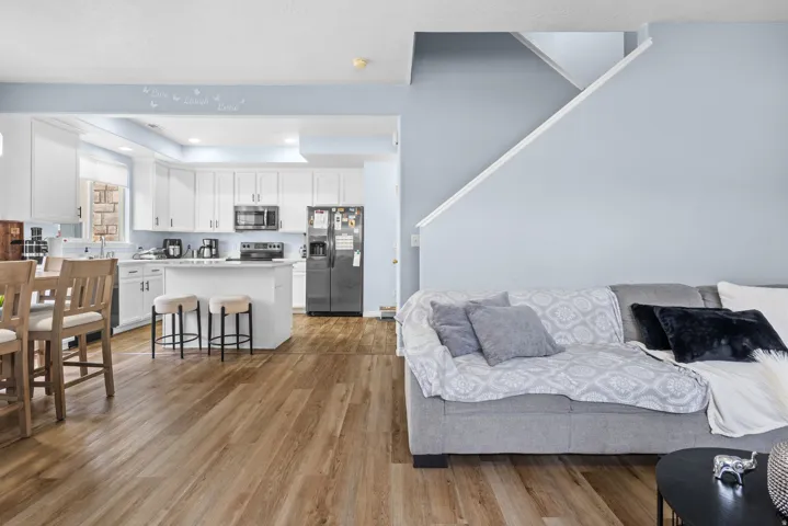 Living room with light wood-style flooring, recessed lighting, and a raised ceiling