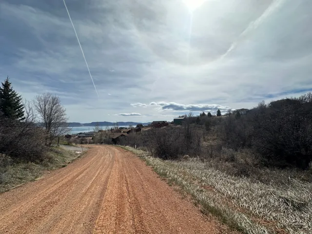 View of dirt / gravel road with a mountain view and a view of rural / pastoral area