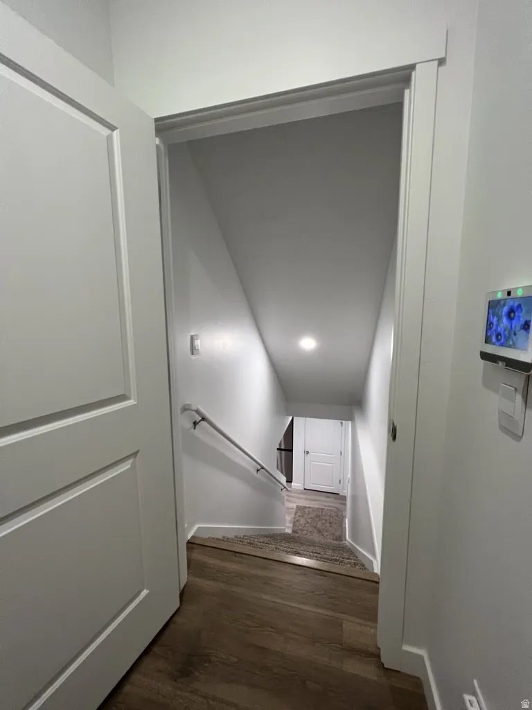Stairway featuring wood finished floors and baseboards