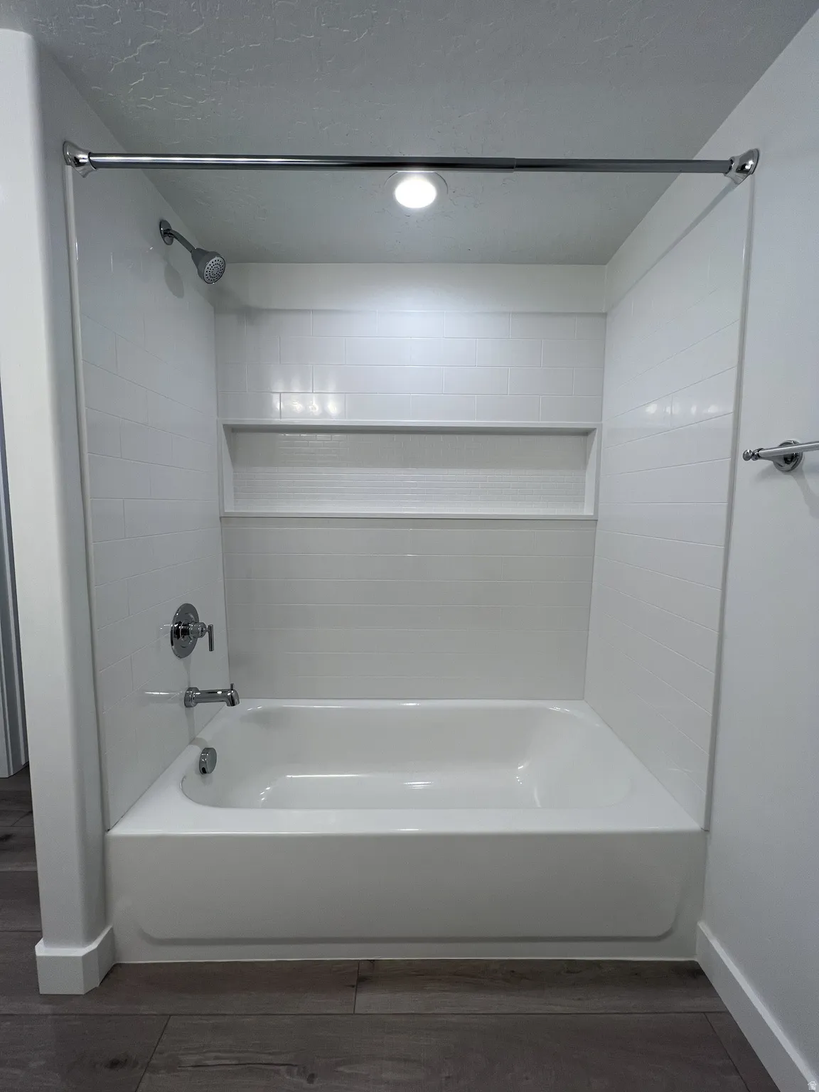 Full bathroom with bathing tub / shower combination and dark wood finished floors