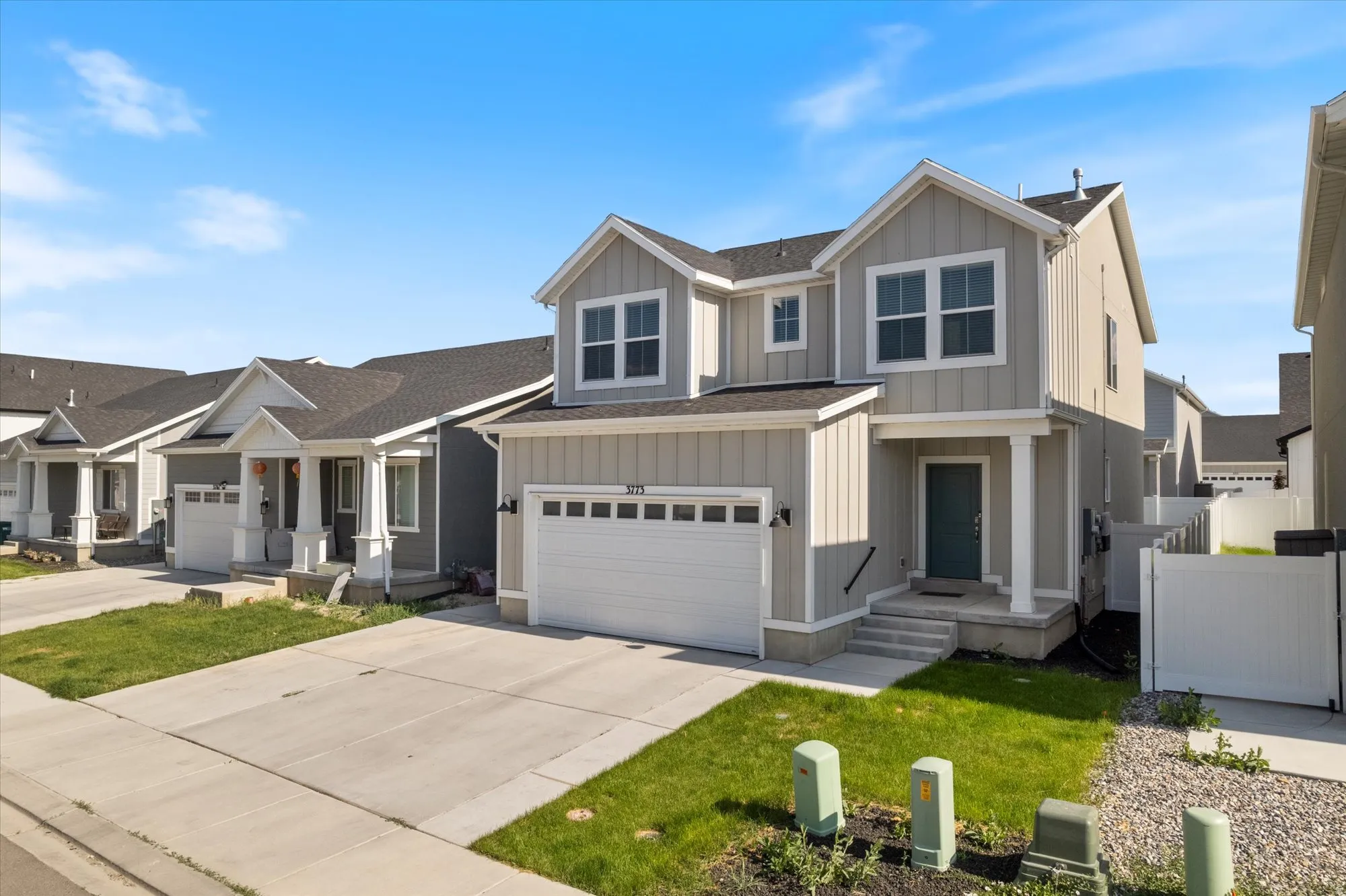Craftsman-style house with concrete driveway, board and batten siding, roof with shingles, and a garage