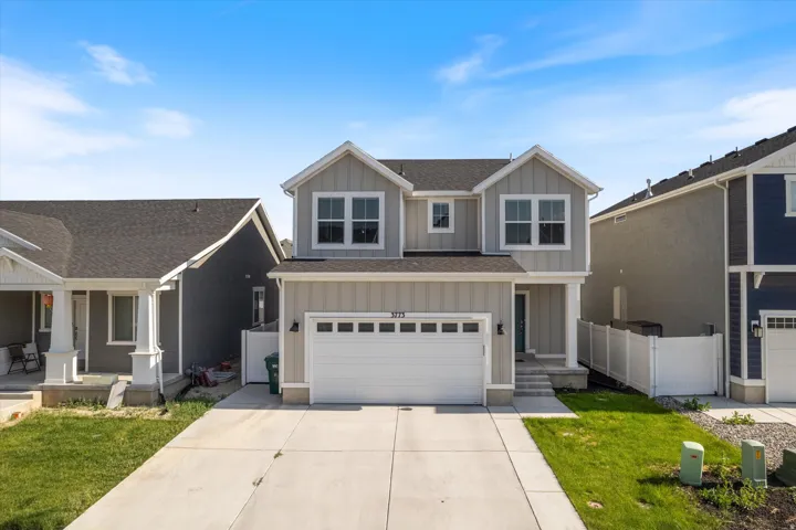 View of front of property with board and batten siding, an attached garage, a shingled roof, concrete driveway, and a porch