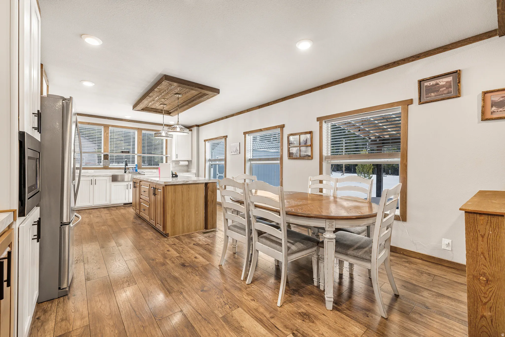 Dining area featuring light wood finished floors, recessed lighting, and ornamental molding