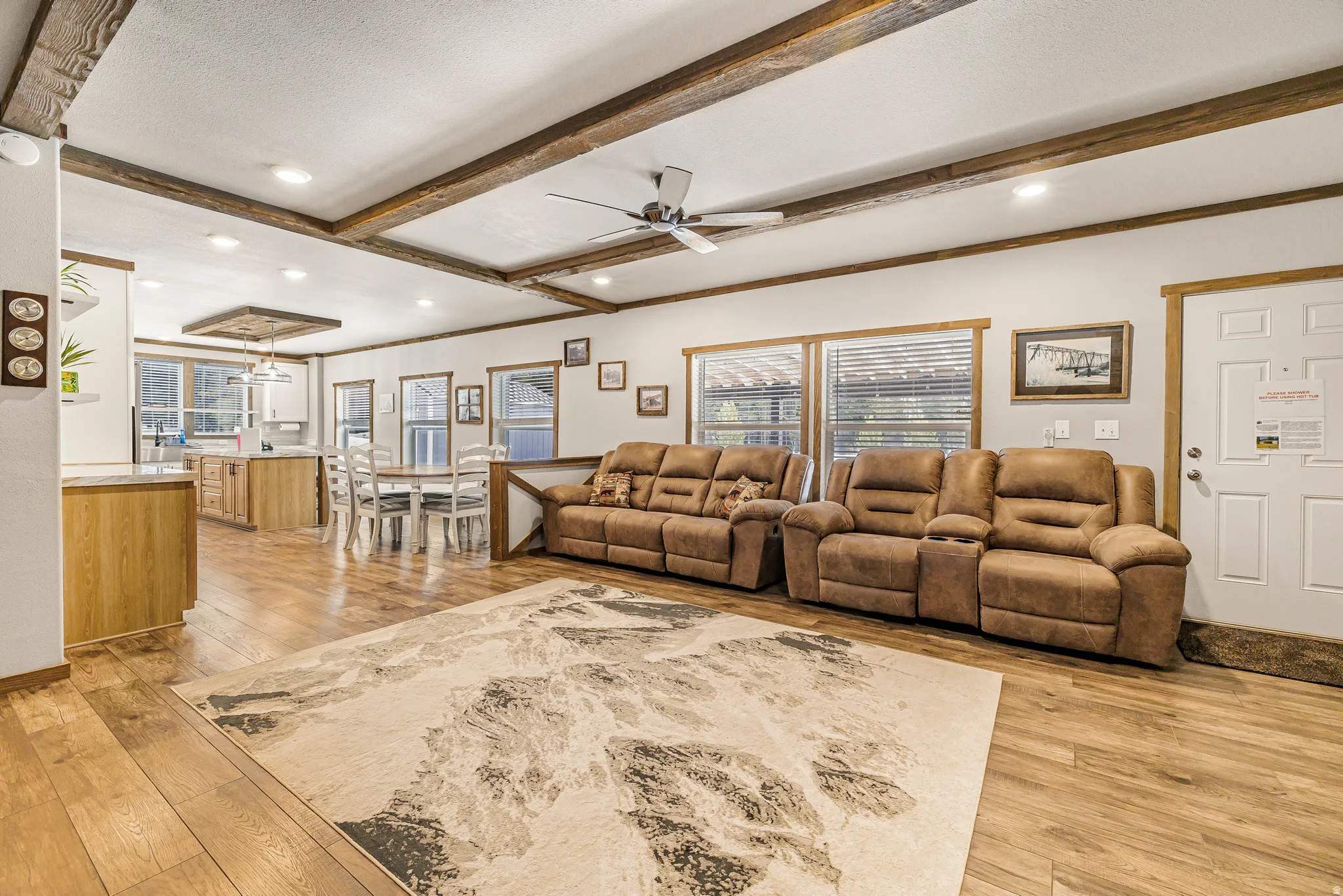 Living room featuring ceiling fan, light wood-style flooring, crown molding, recessed lighting, and a textured ceiling