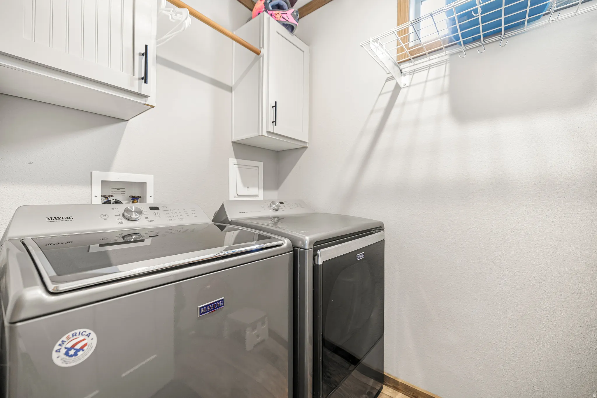 Laundry area featuring cabinet space and independent washer and dryer