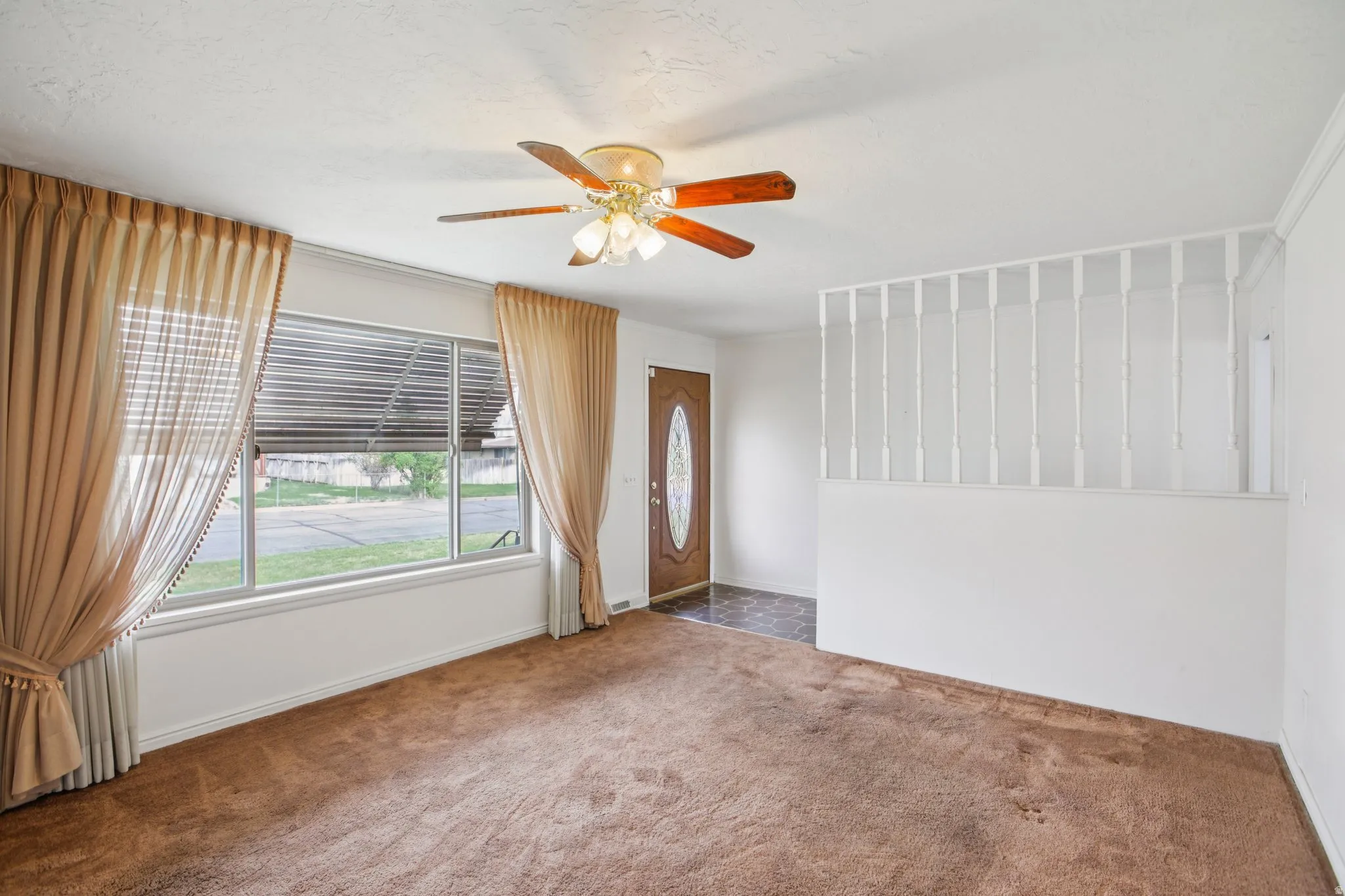 Spare room with a ceiling fan and carpet