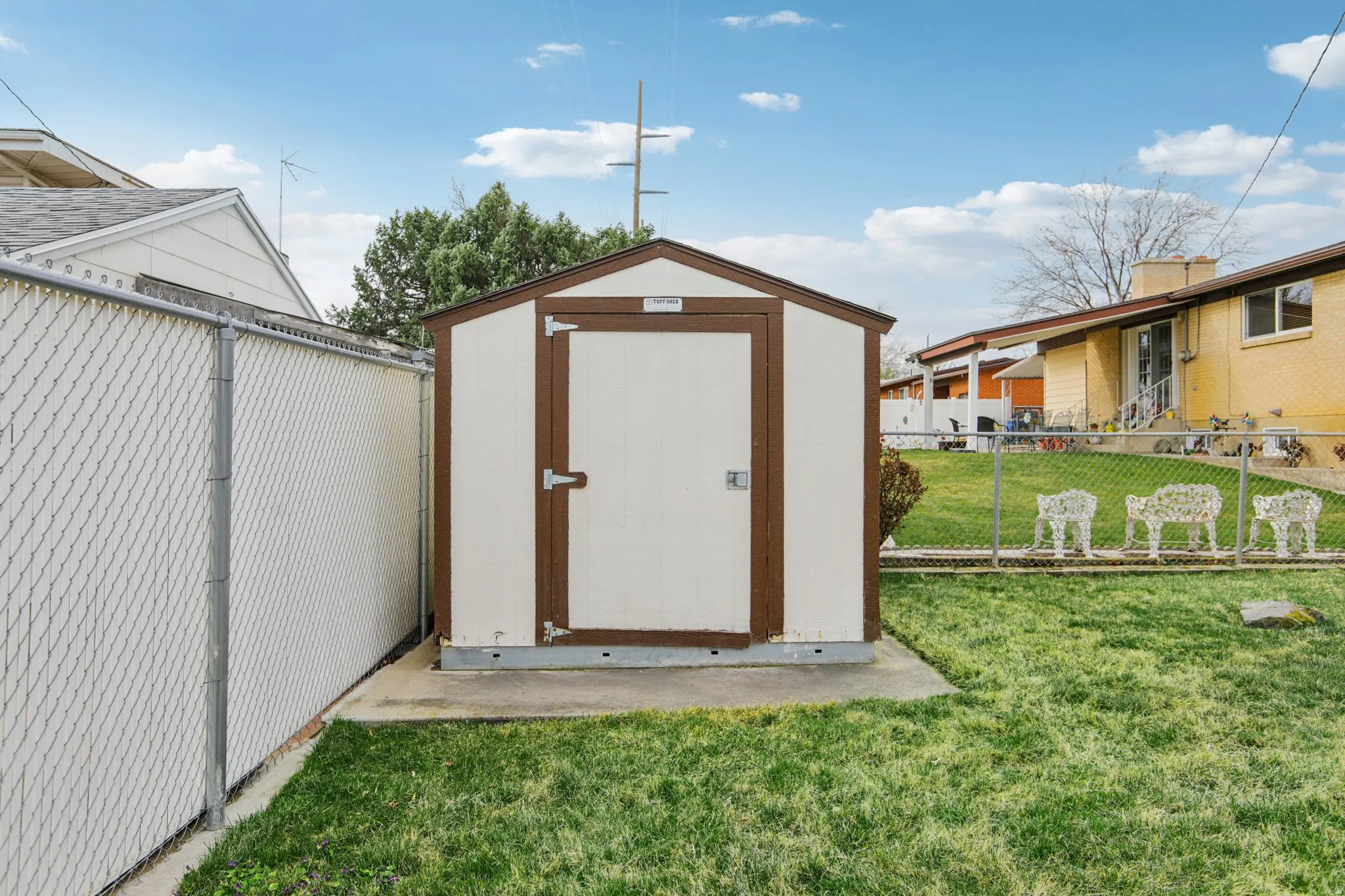 View of shed with a fenced backyard