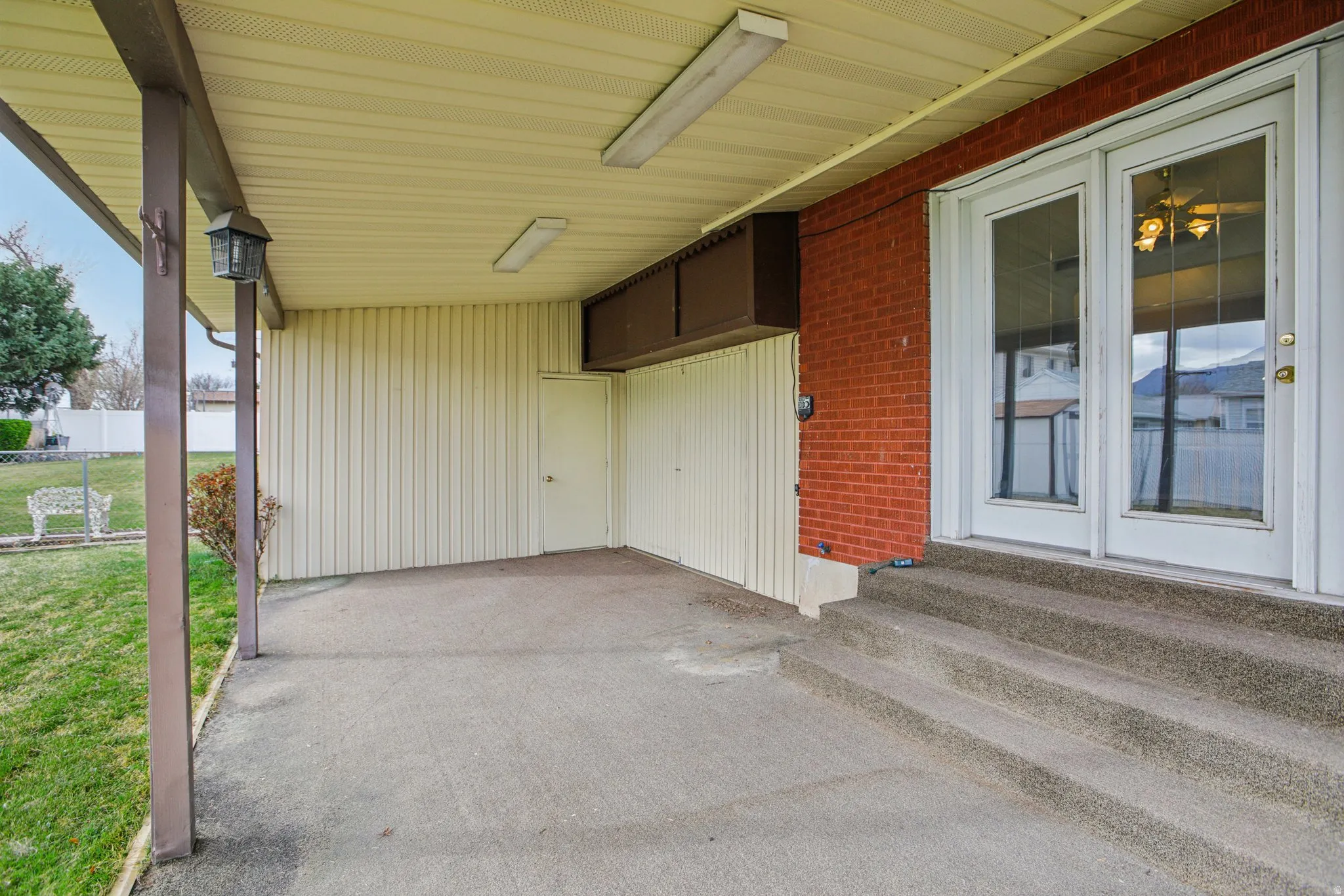 View of patio / terrace with a carport and entry steps