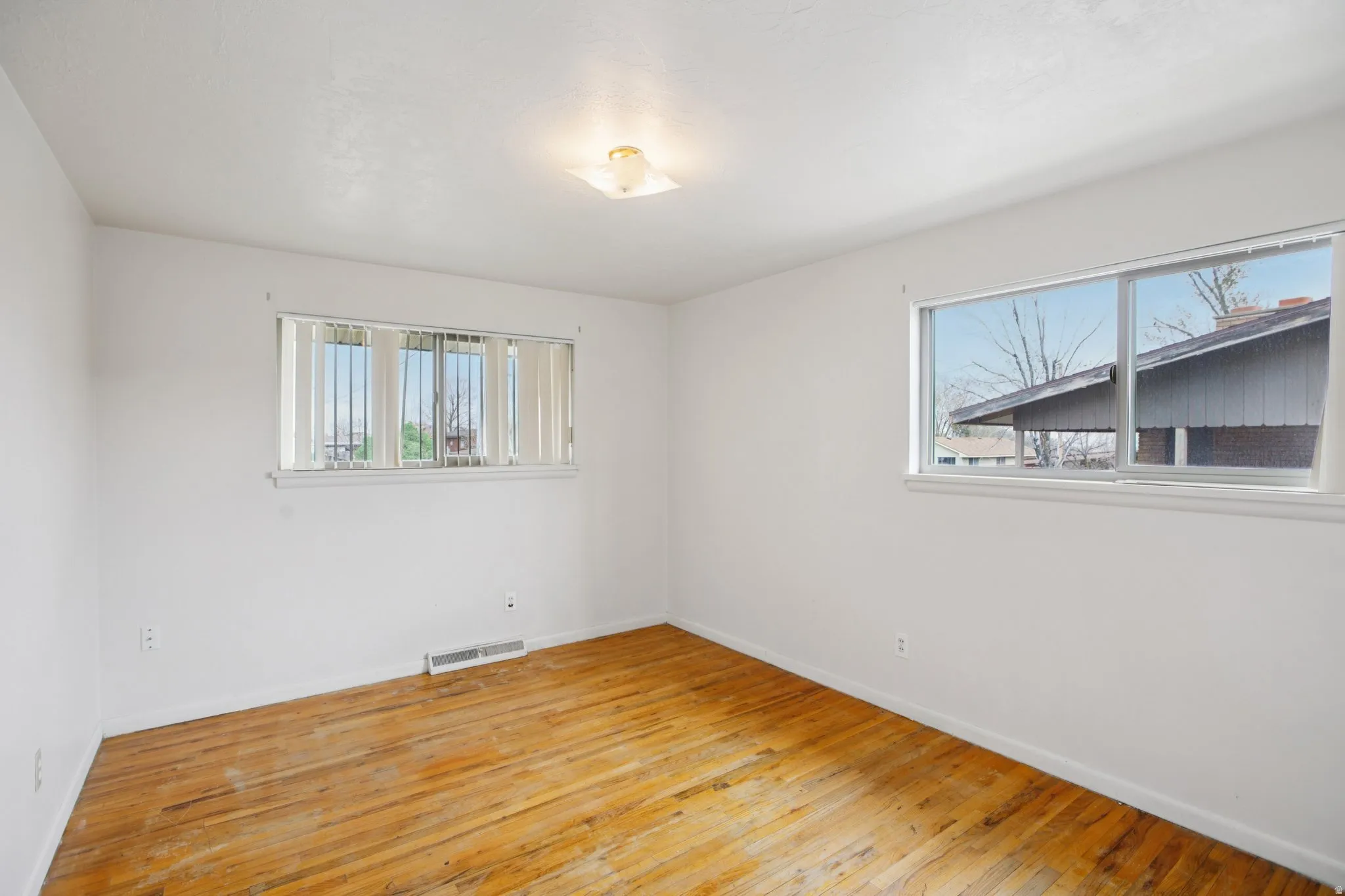 Empty room with light wood-style floors and baseboards