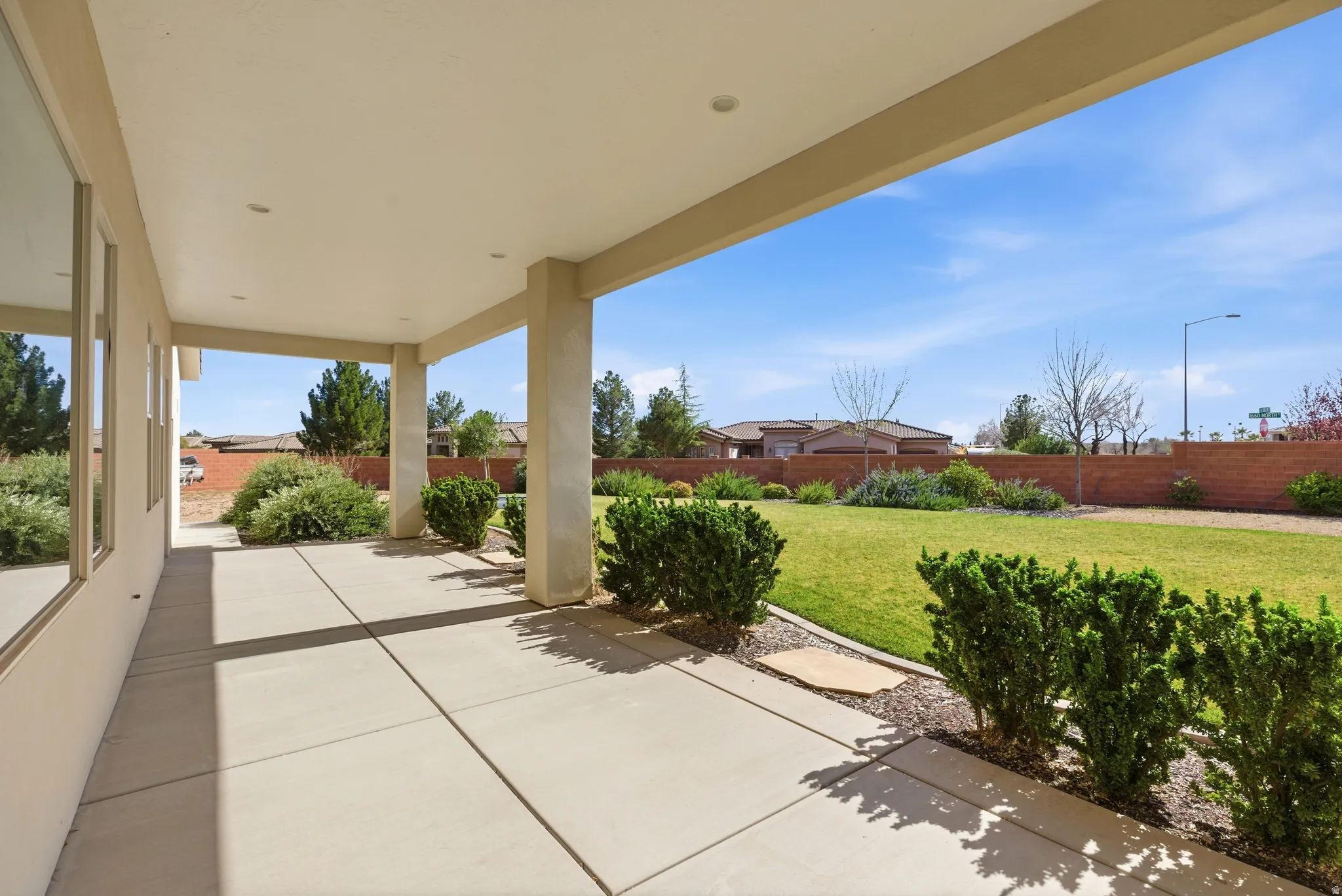 Fenced backyard with a patio area