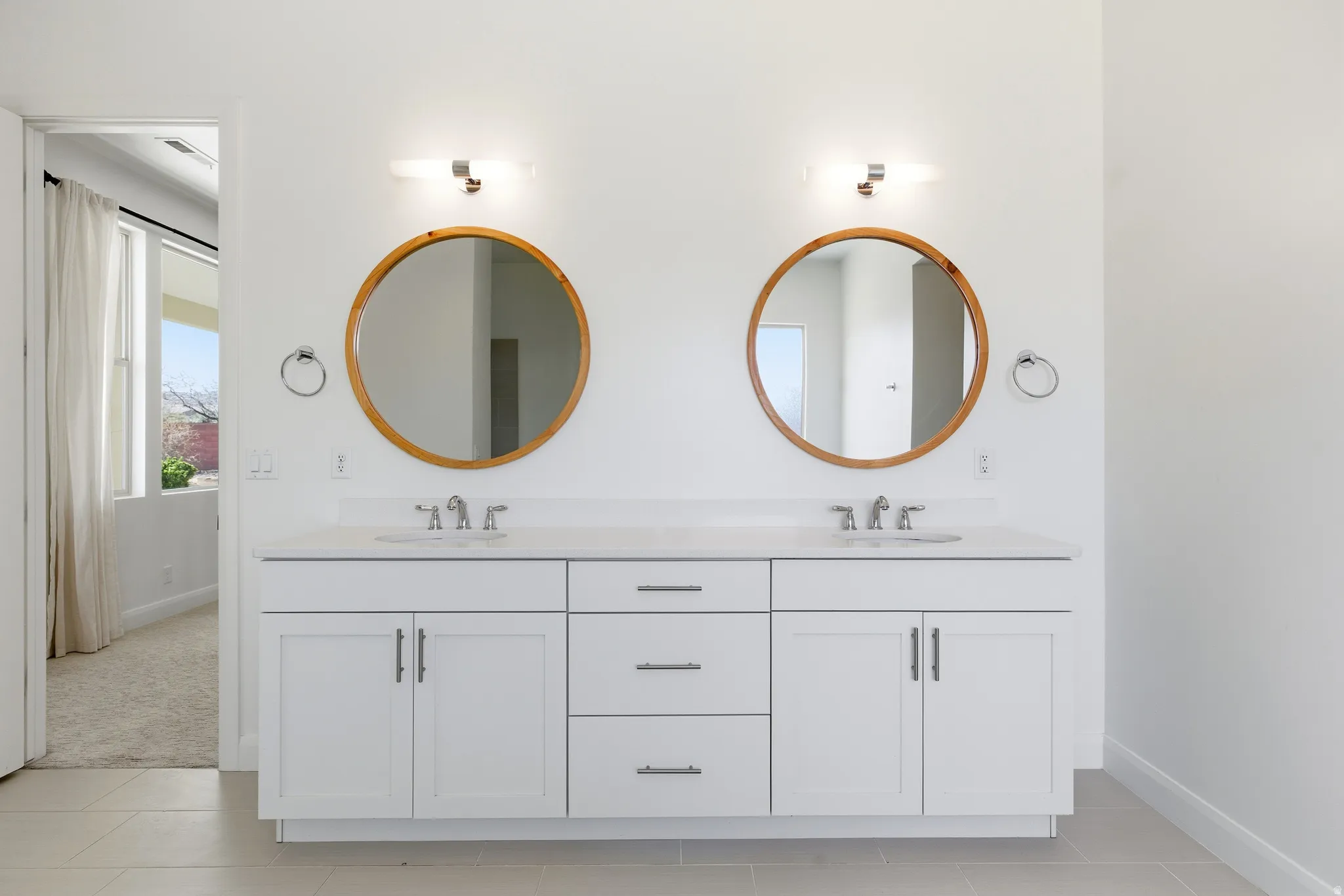 Bathroom featuring double vanity and baseboards