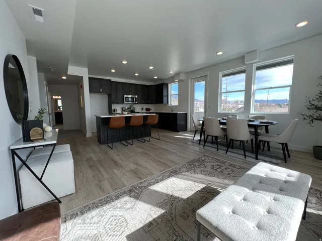 Living area with light wood-style flooring and recessed lighting