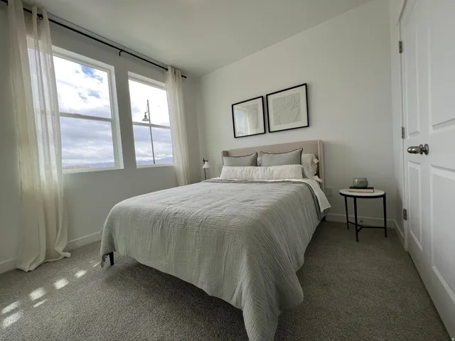 Carpeted bedroom featuring baseboards