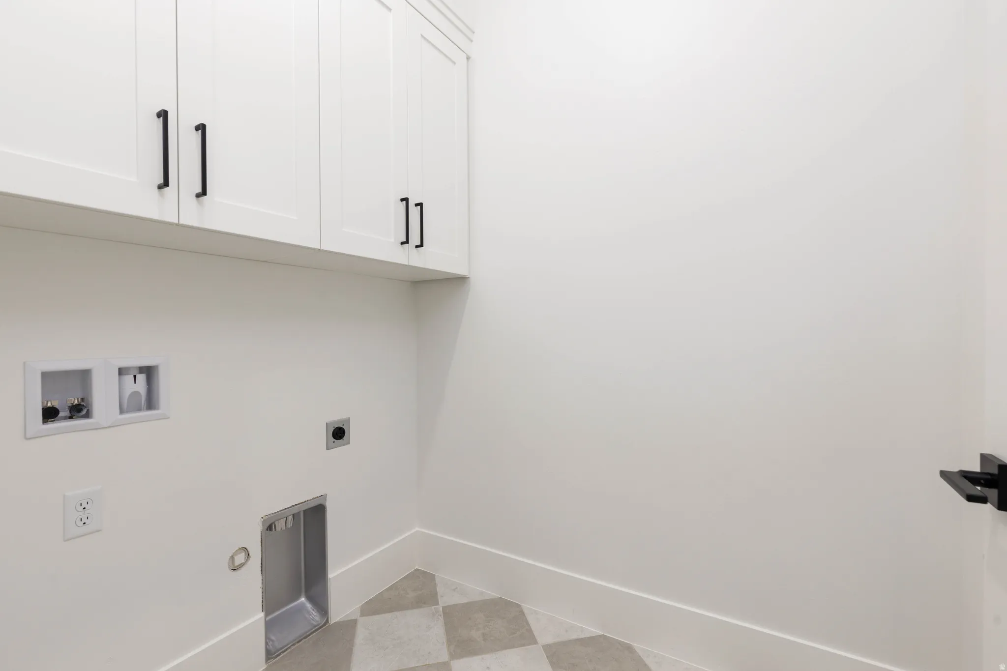 Laundry room with cabinet space, hookup for an electric dryer, washer hookup, light floors, and gas dryer hookup