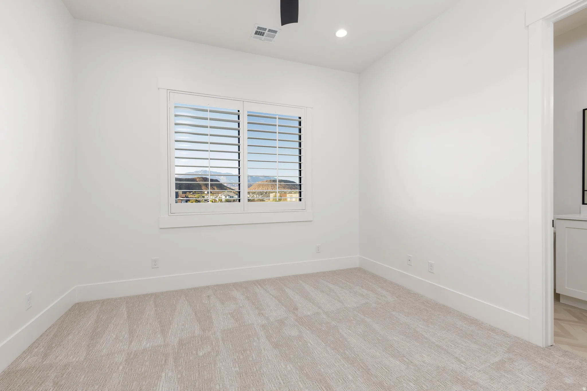 Spare room featuring recessed lighting, light carpet, and ceiling fan