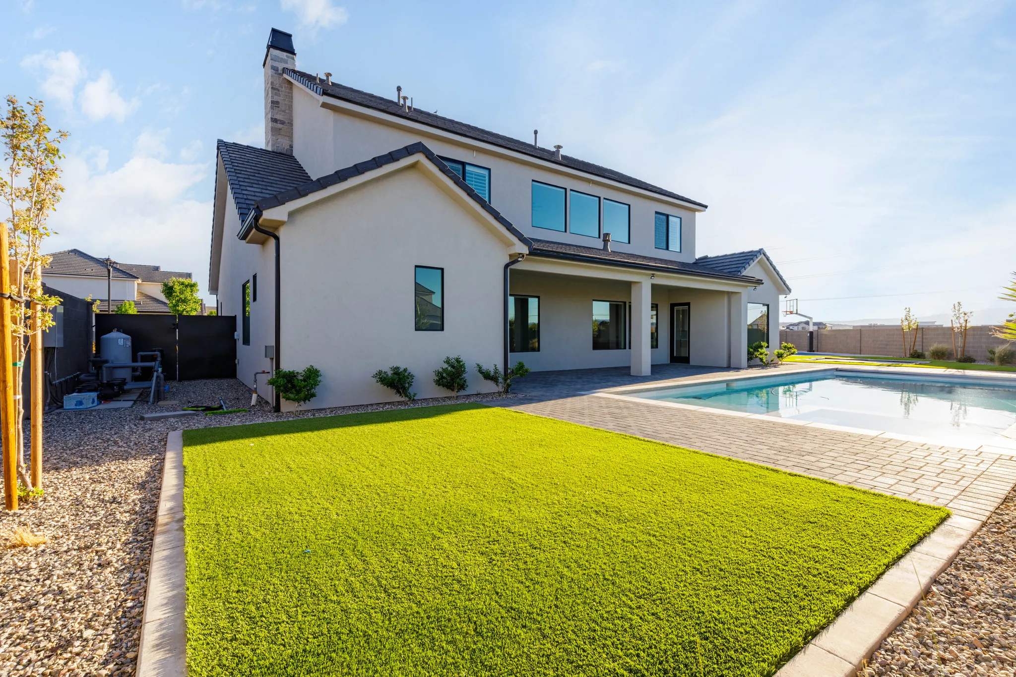 Rear view of house featuring a patio, a fenced backyard, and stucco siding