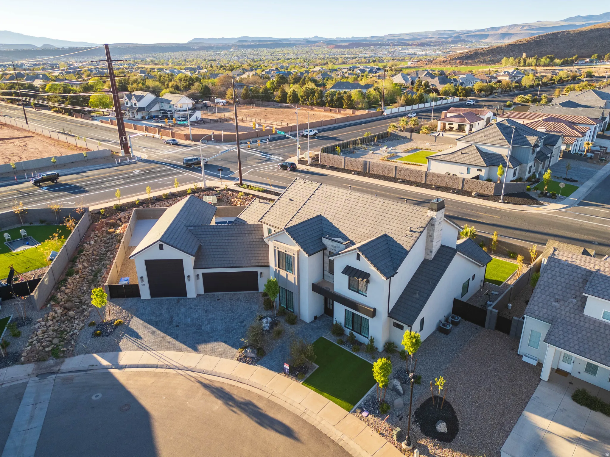 Aerial perspective of suburban area featuring a mountainous background