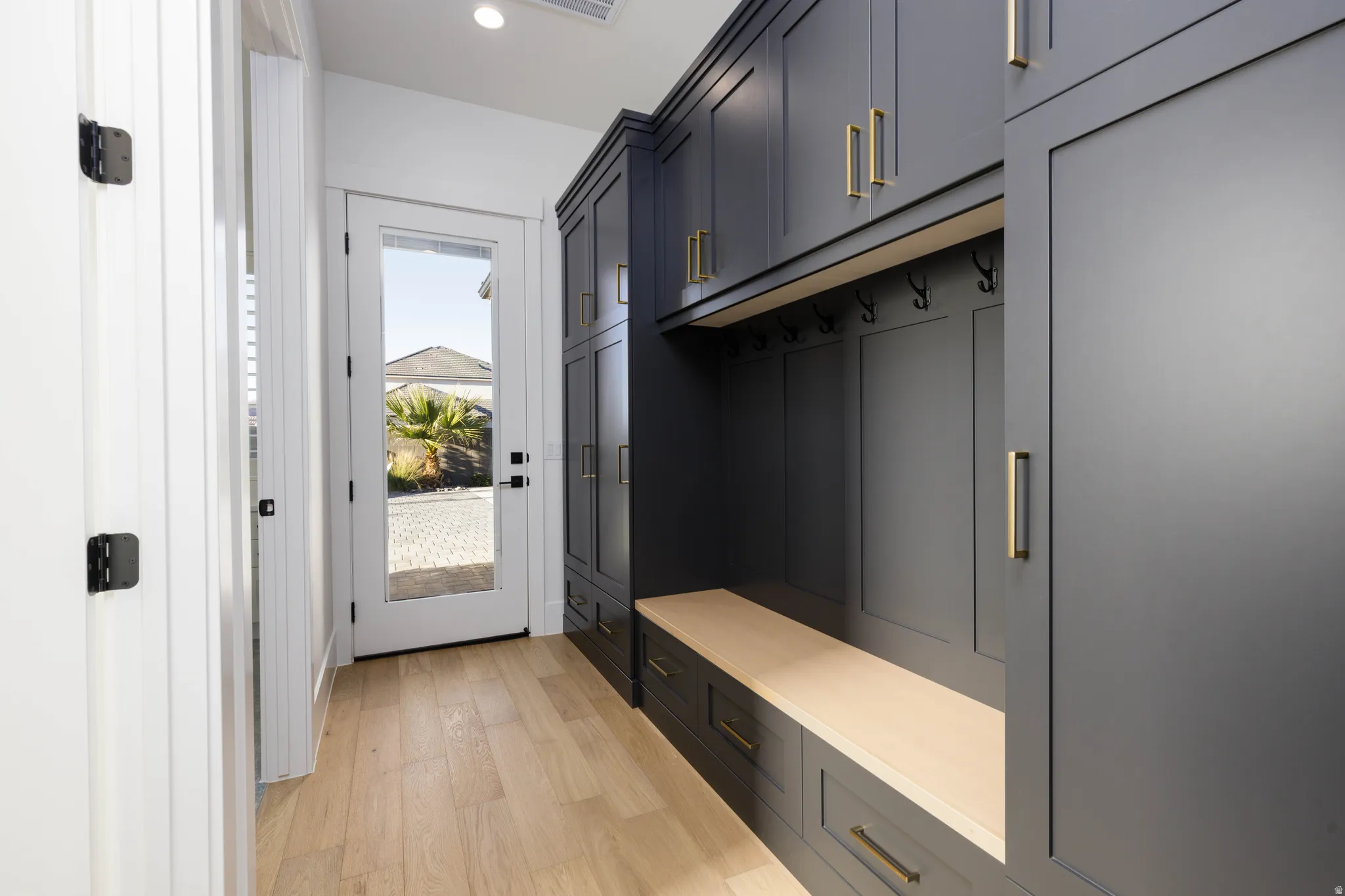 Mudroom with light wood-style flooring and recessed lighting