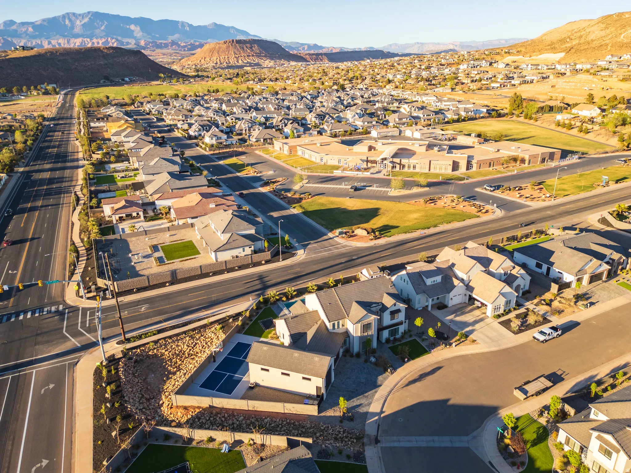 Aerial perspective of suburban area featuring a mountainous background