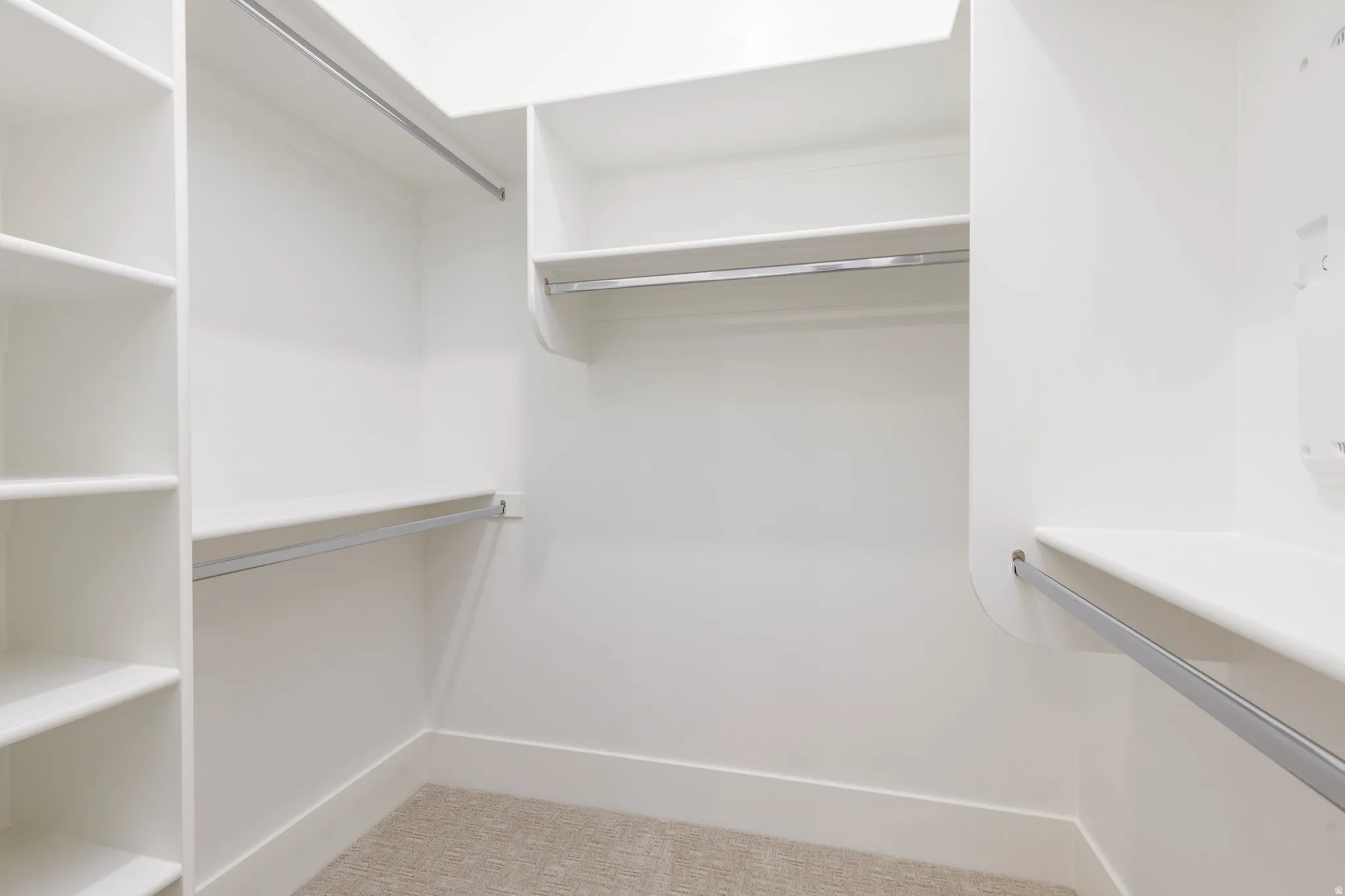 Walk in closet with light carpet