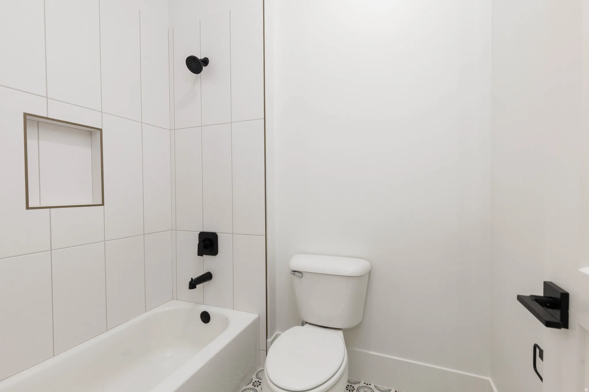 Full bath featuring toilet and  shower combination