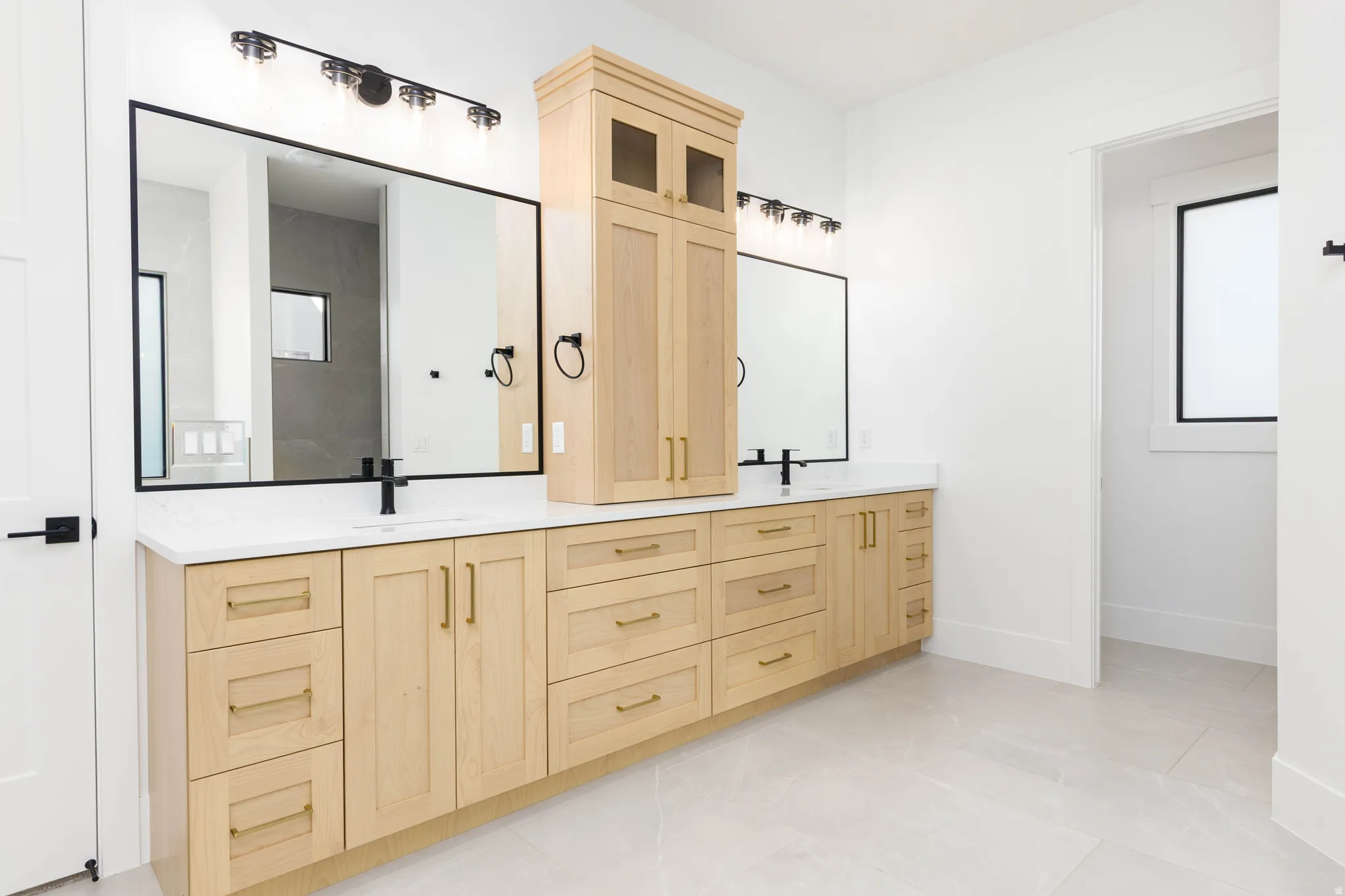 Full bath featuring double vanity and light tile patterned floors
