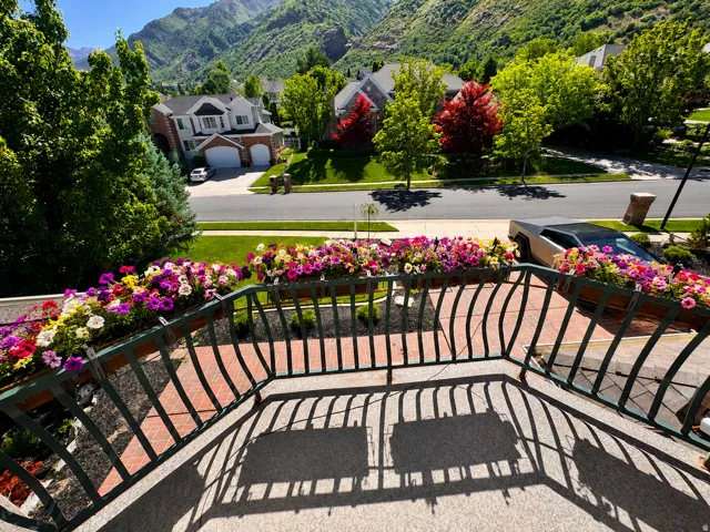 Balcony with vibrant floral boxes and dark metal railings AI-staged or enhanced
