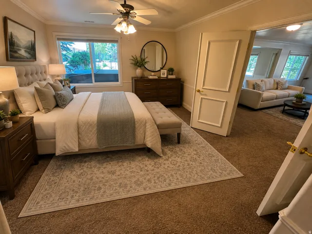 Bedroom featuring a window with exterior visibility, crown molding, and a ceiling fan with integrated lighting AI-staged or enhanced