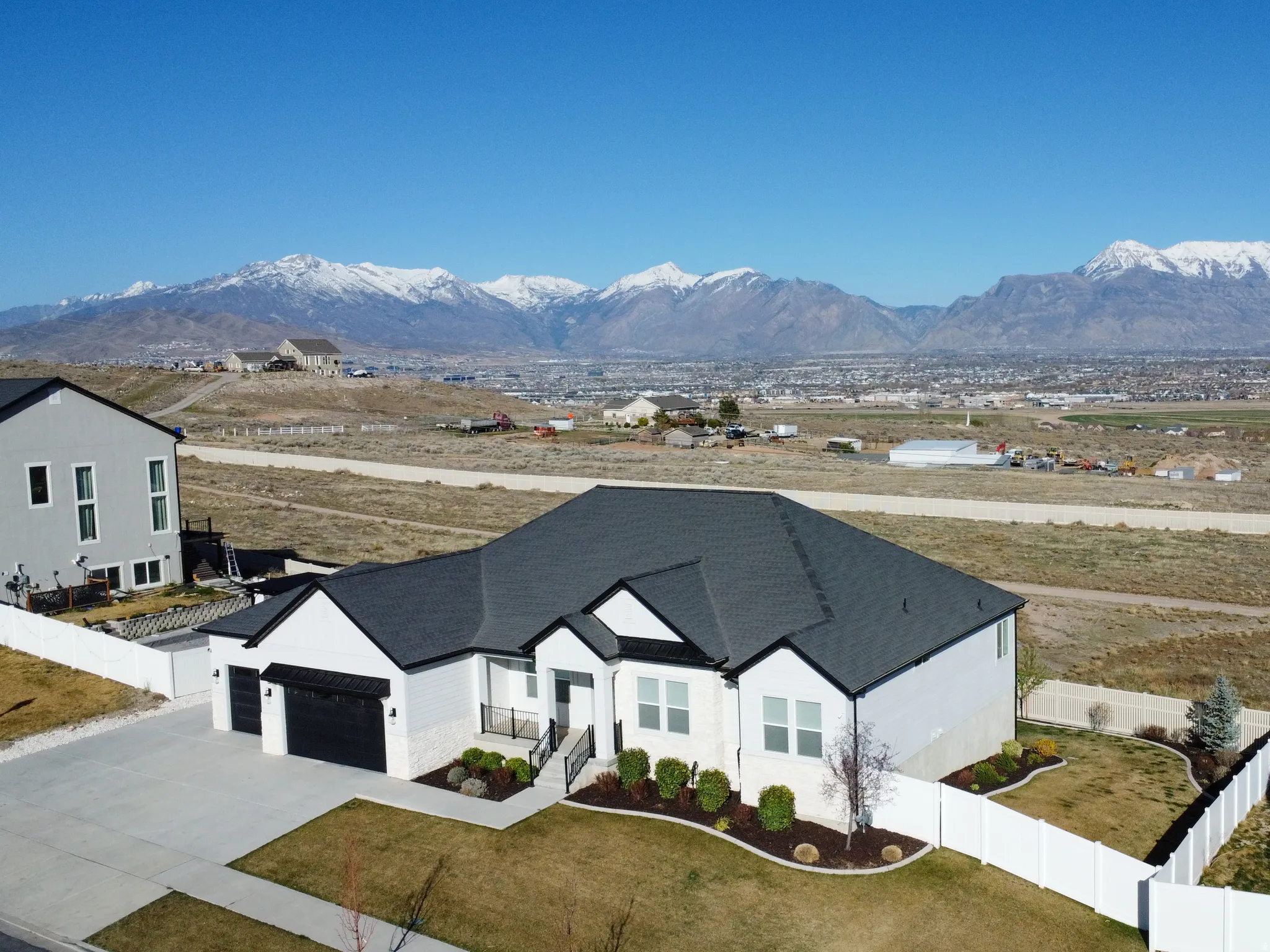 View of front of house featuring a garage, a mountain view, and driveway