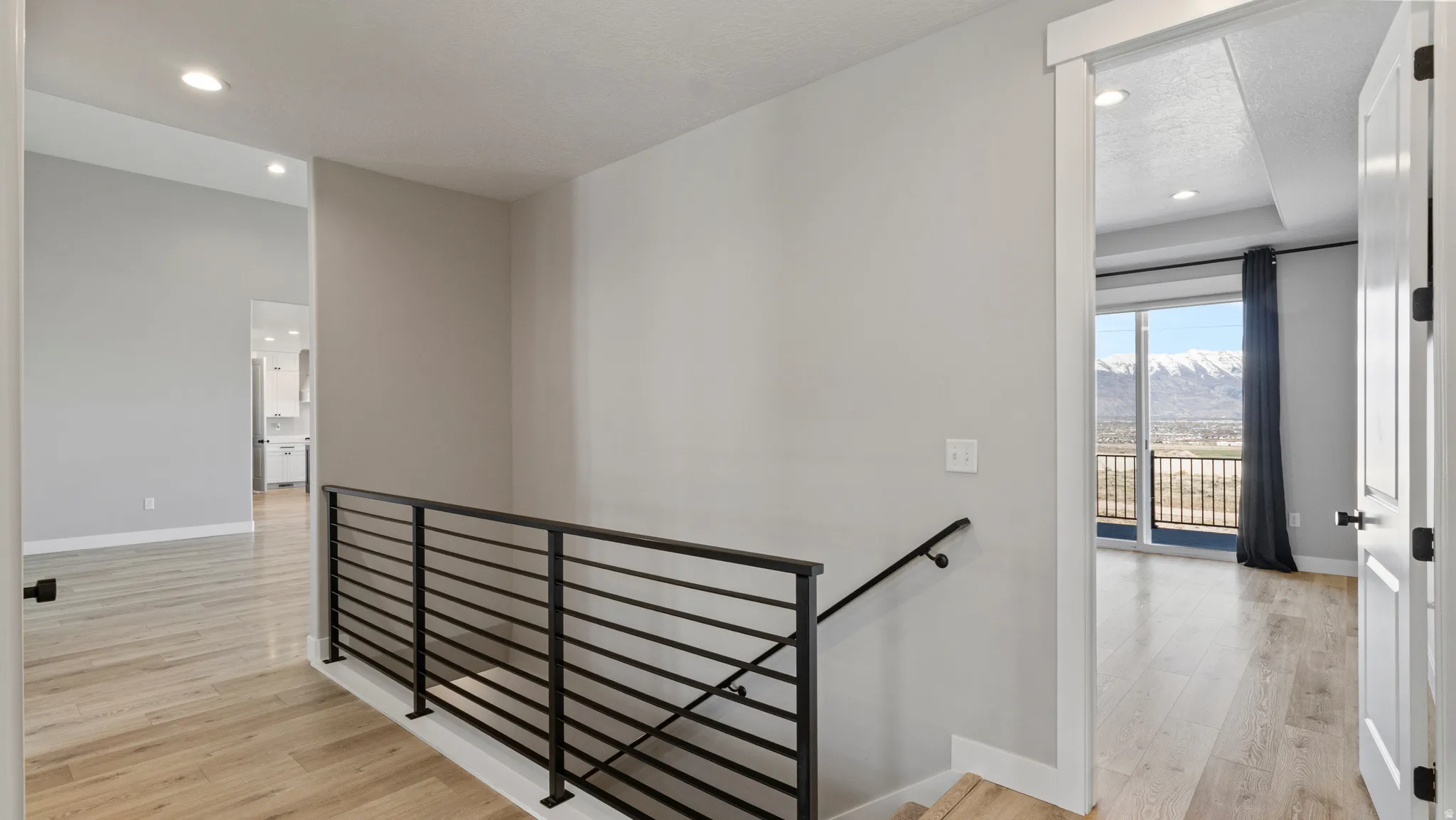 Stairs featuring recessed lighting, a mountain view, and wood finished floors