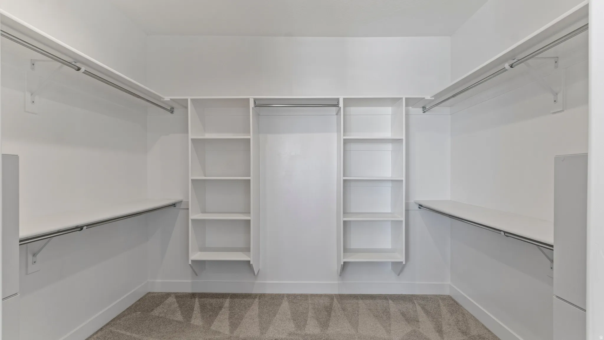 Walk in closet with light carpet