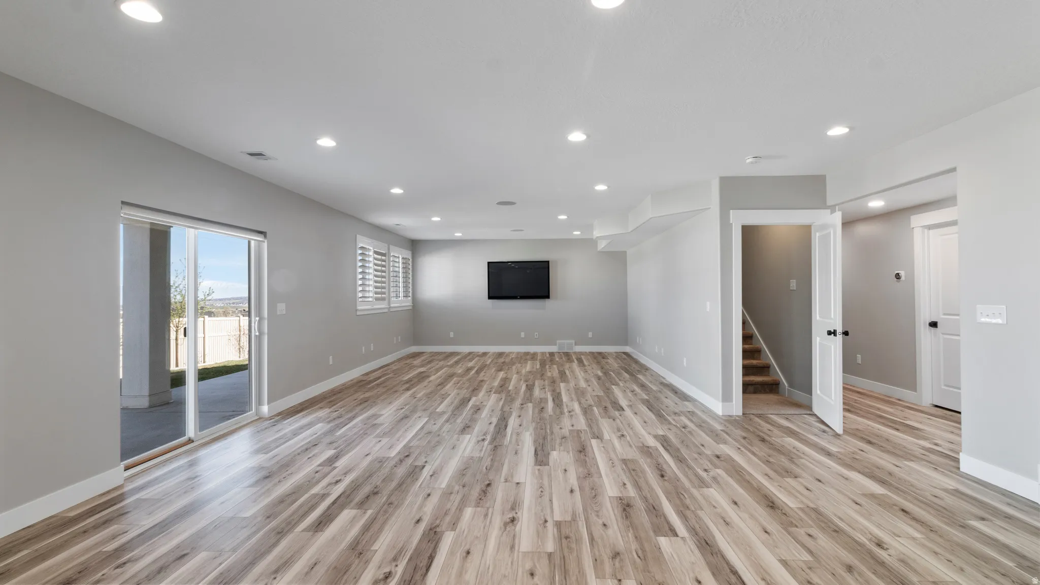 Unfurnished living room with light wood-style floors and recessed lighting