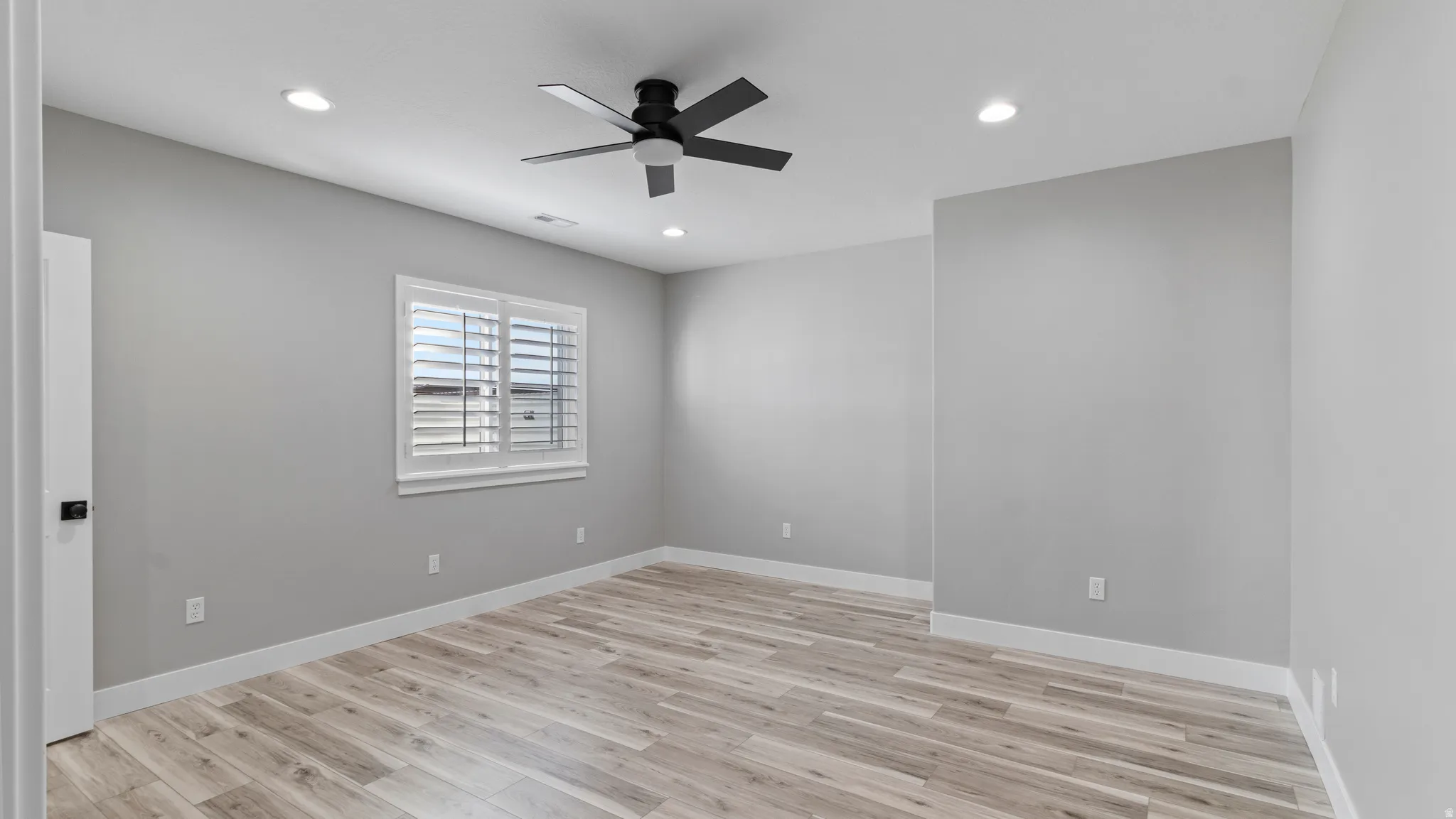 Spare room featuring ceiling fan, light wood finished floors, and recessed lighting