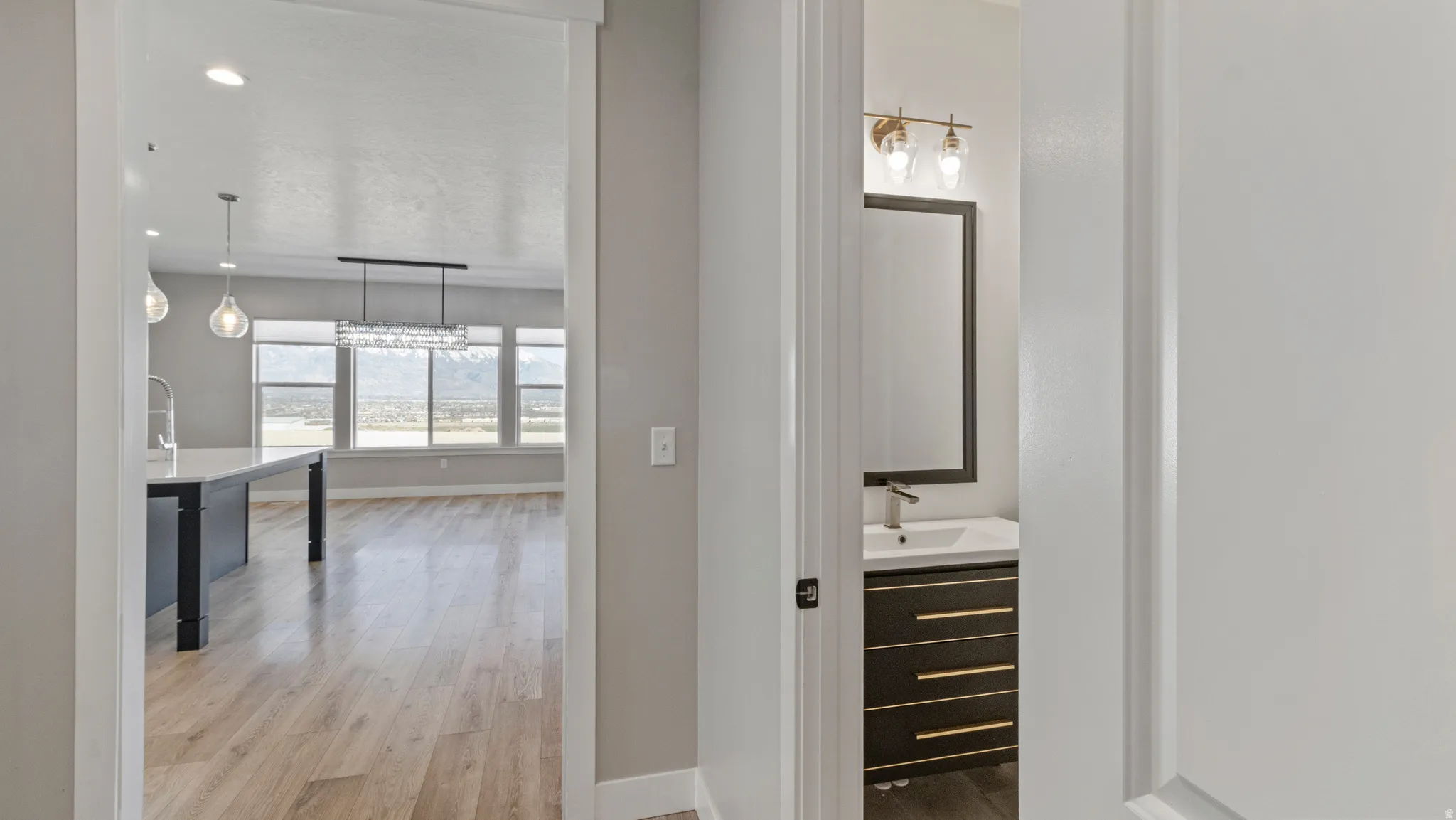 Corridor featuring light wood-style floors and recessed lighting