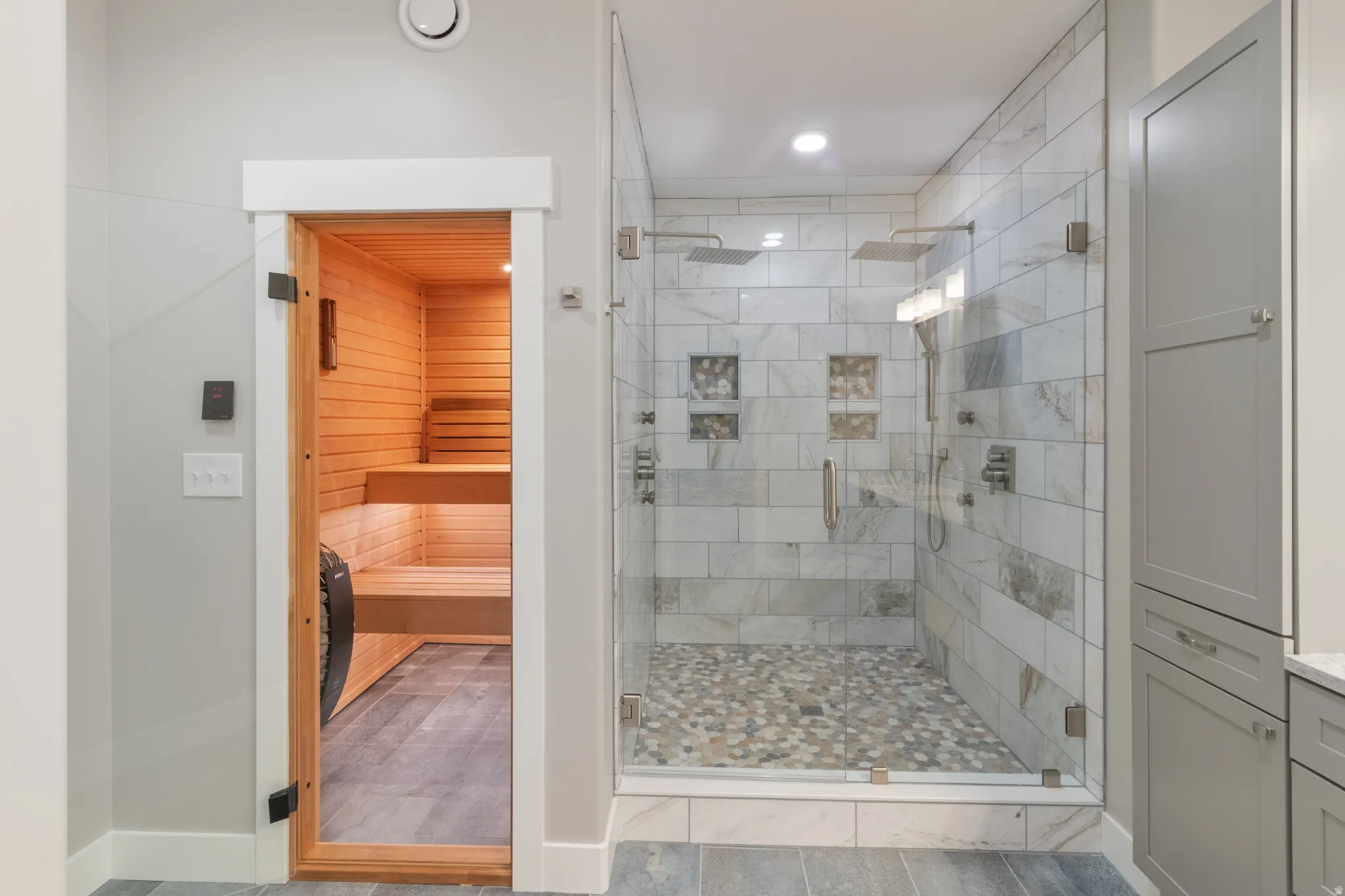 Full bath with a relaxing sauna, a stall shower, and vanity