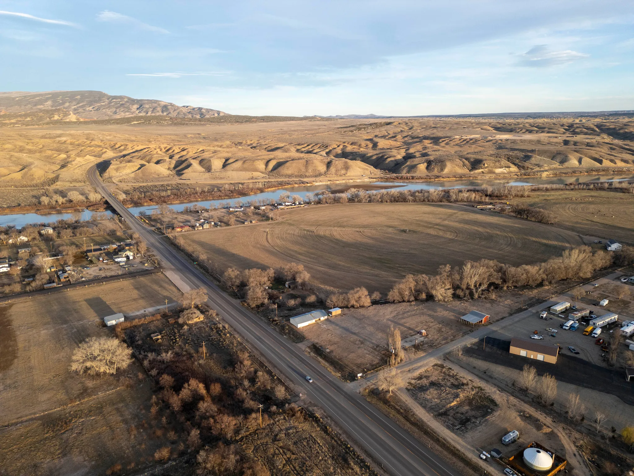 Aerial overview of property's location with rural landscape and a mountainous background