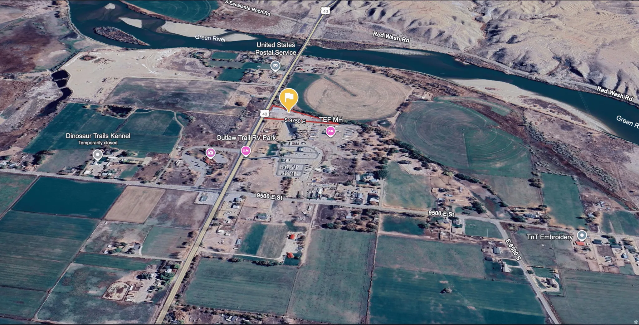 Aerial view of property and surrounding area featuring a nearby body of water