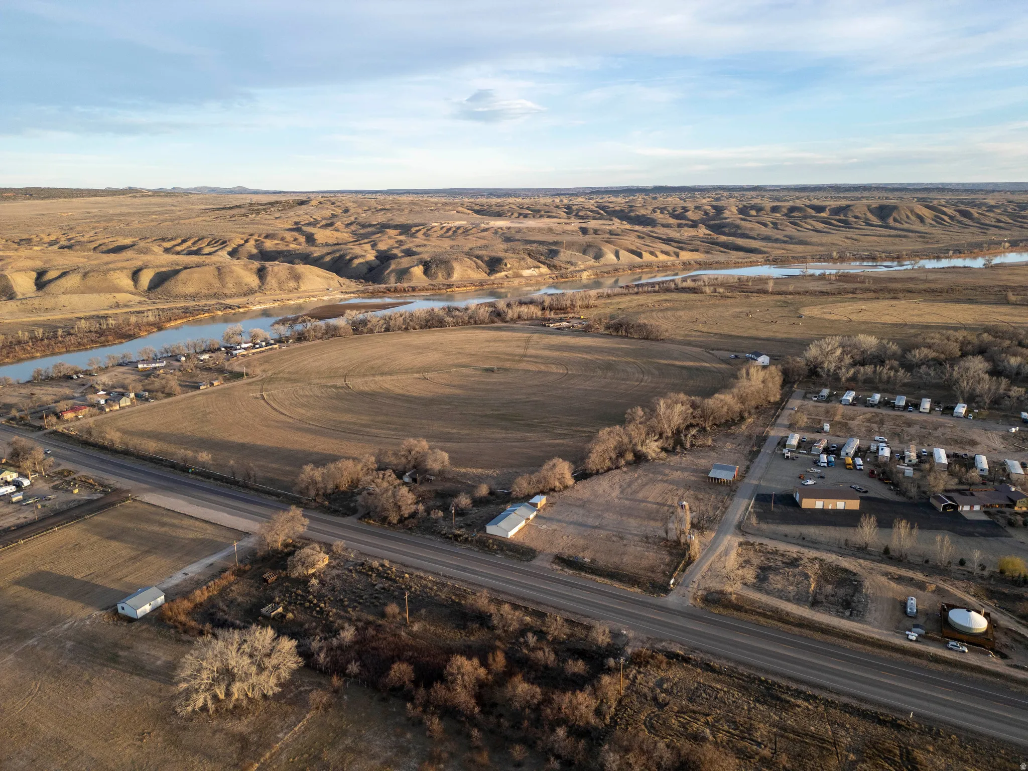 Aerial view of property's location with a large body of water and rural landscape