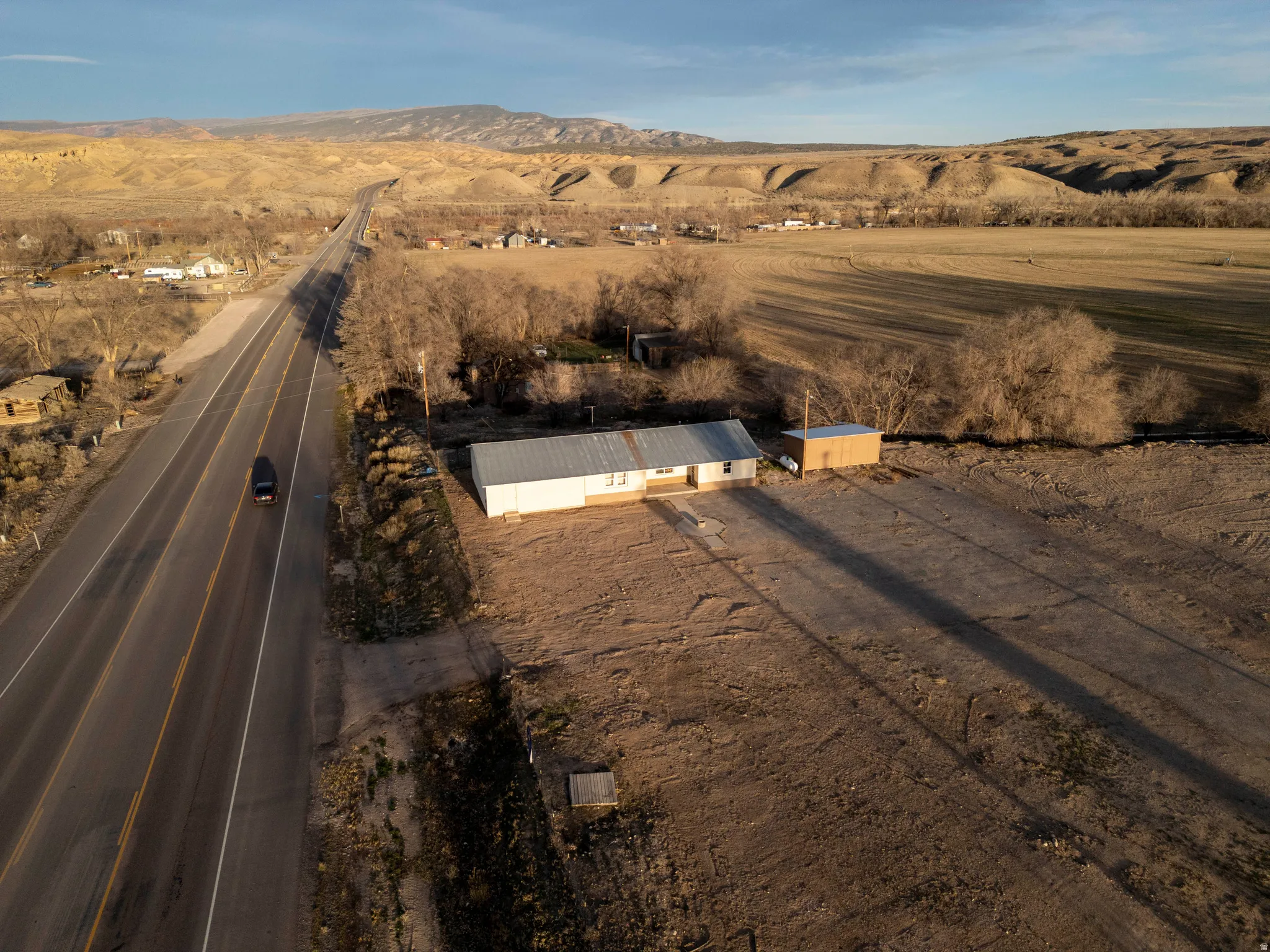 Aerial view of property's location with rural landscape and a mountain backdrop