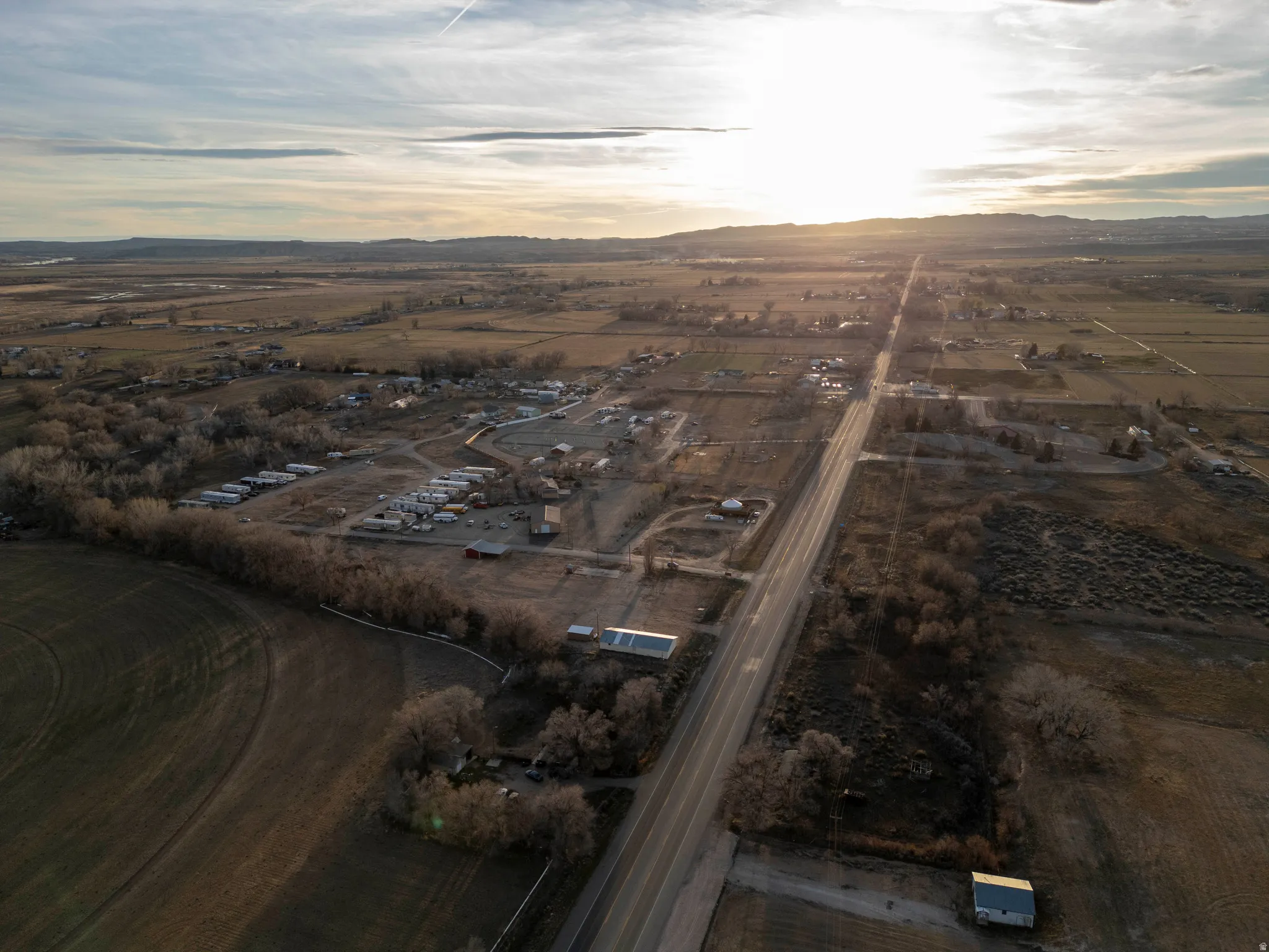 Aerial view at dusk of a view of rural / pastoral area and a mountain view