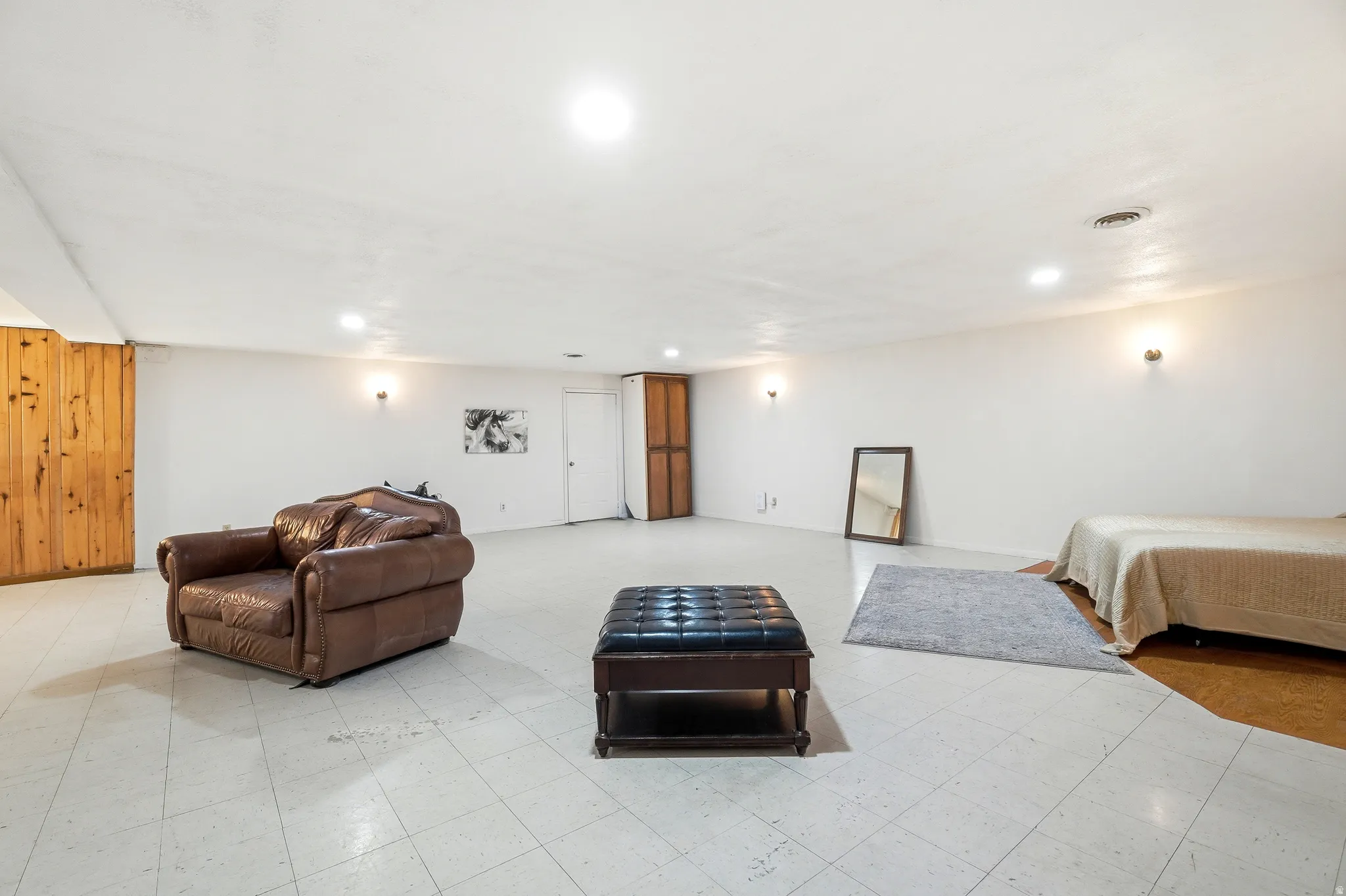 Bedroom with light flooring and recessed lighting
