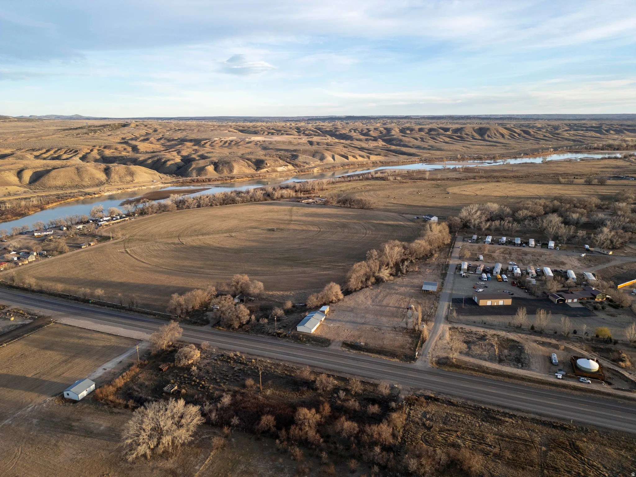 Aerial view of property and surrounding area with a large body of water and rural landscape