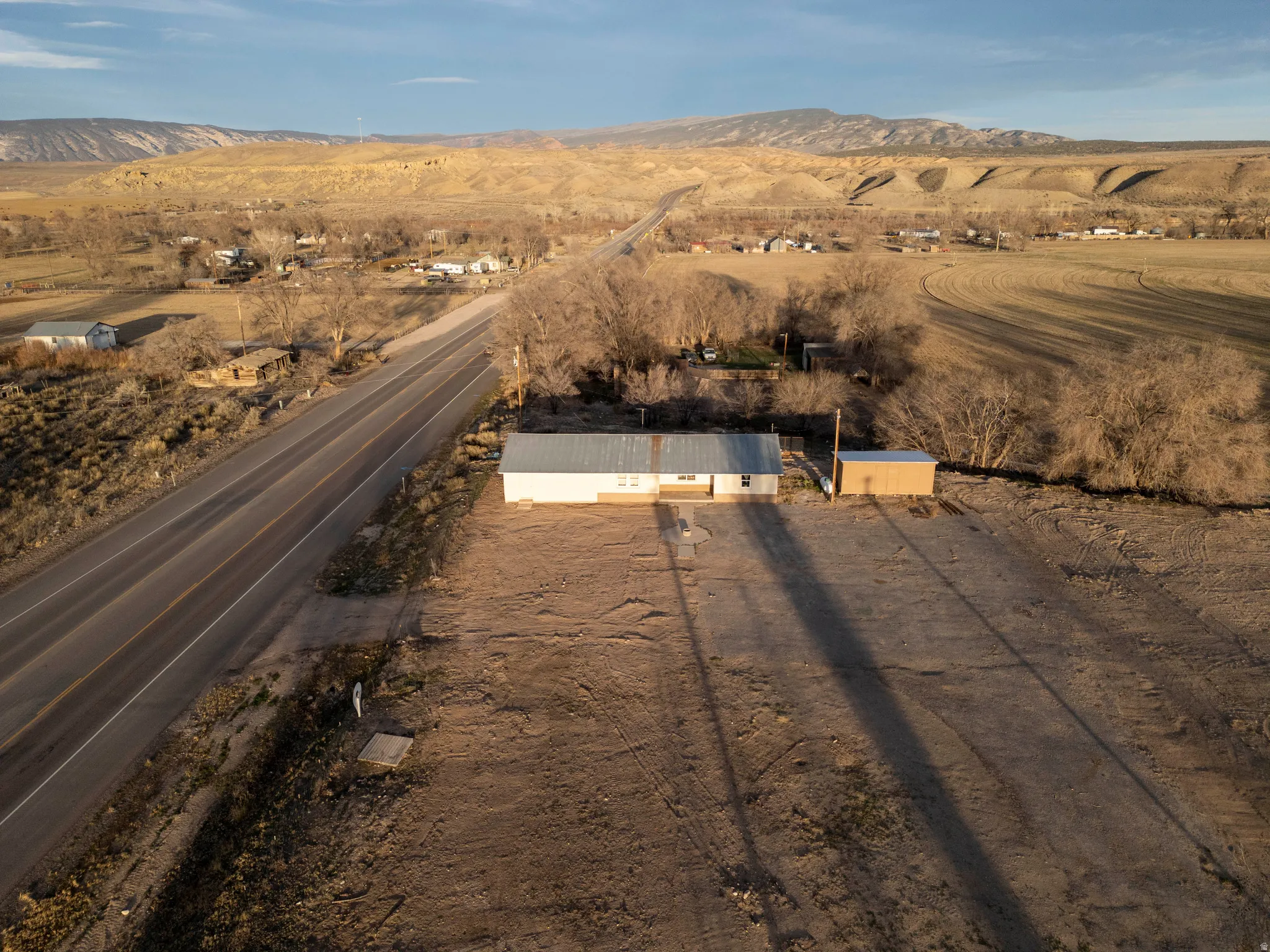 Aerial overview of property's location with a mountainous background and rural landscape