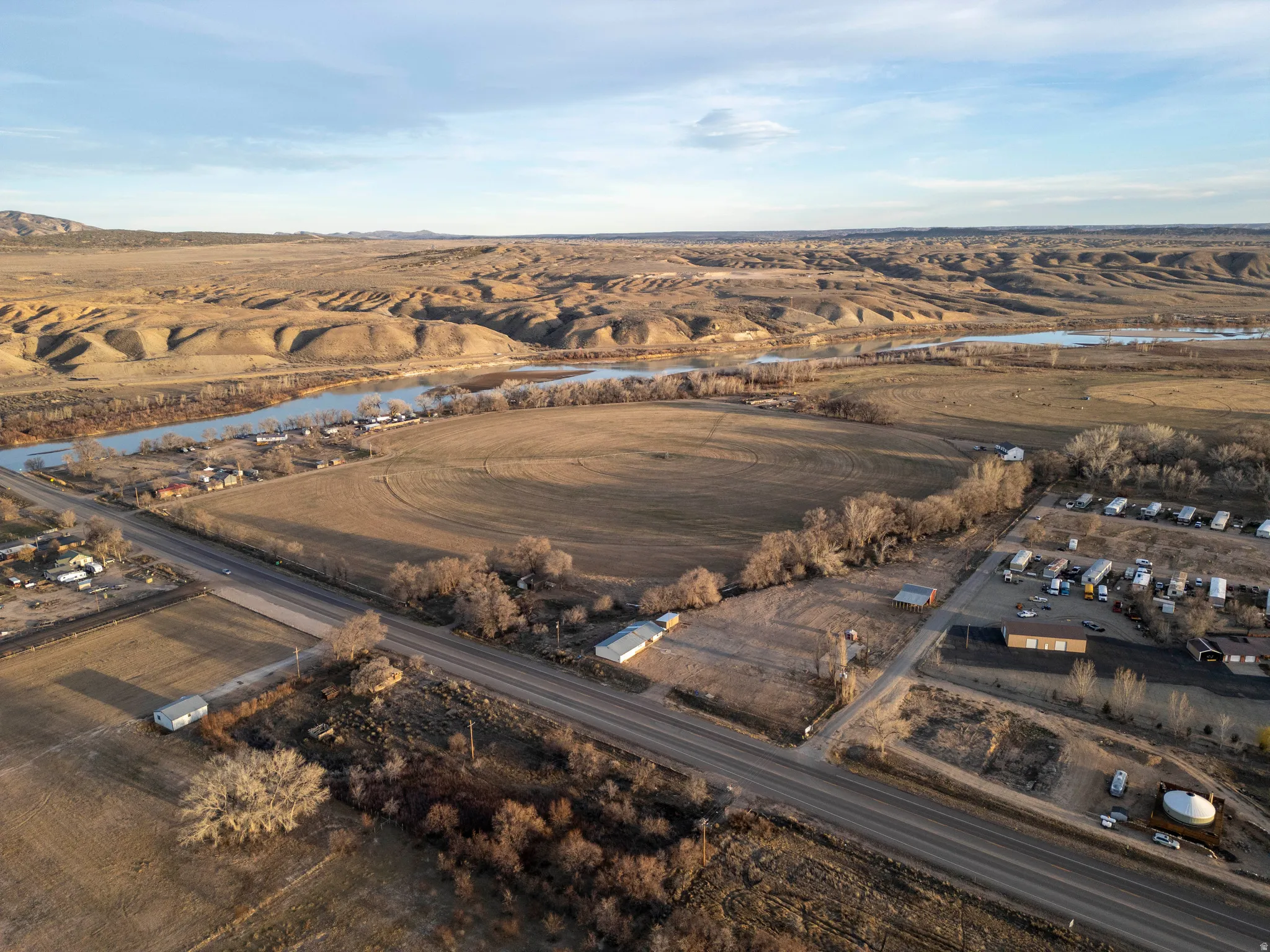 Aerial view of property and surrounding area with a large body of water and rural landscape