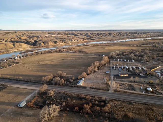 Aerial view of property and surrounding area with a large body of water