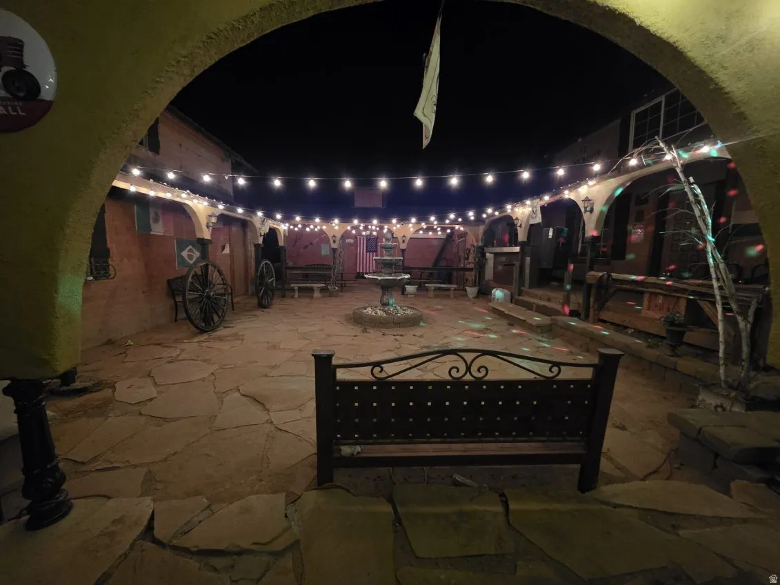 Patio at night featuring a patio area