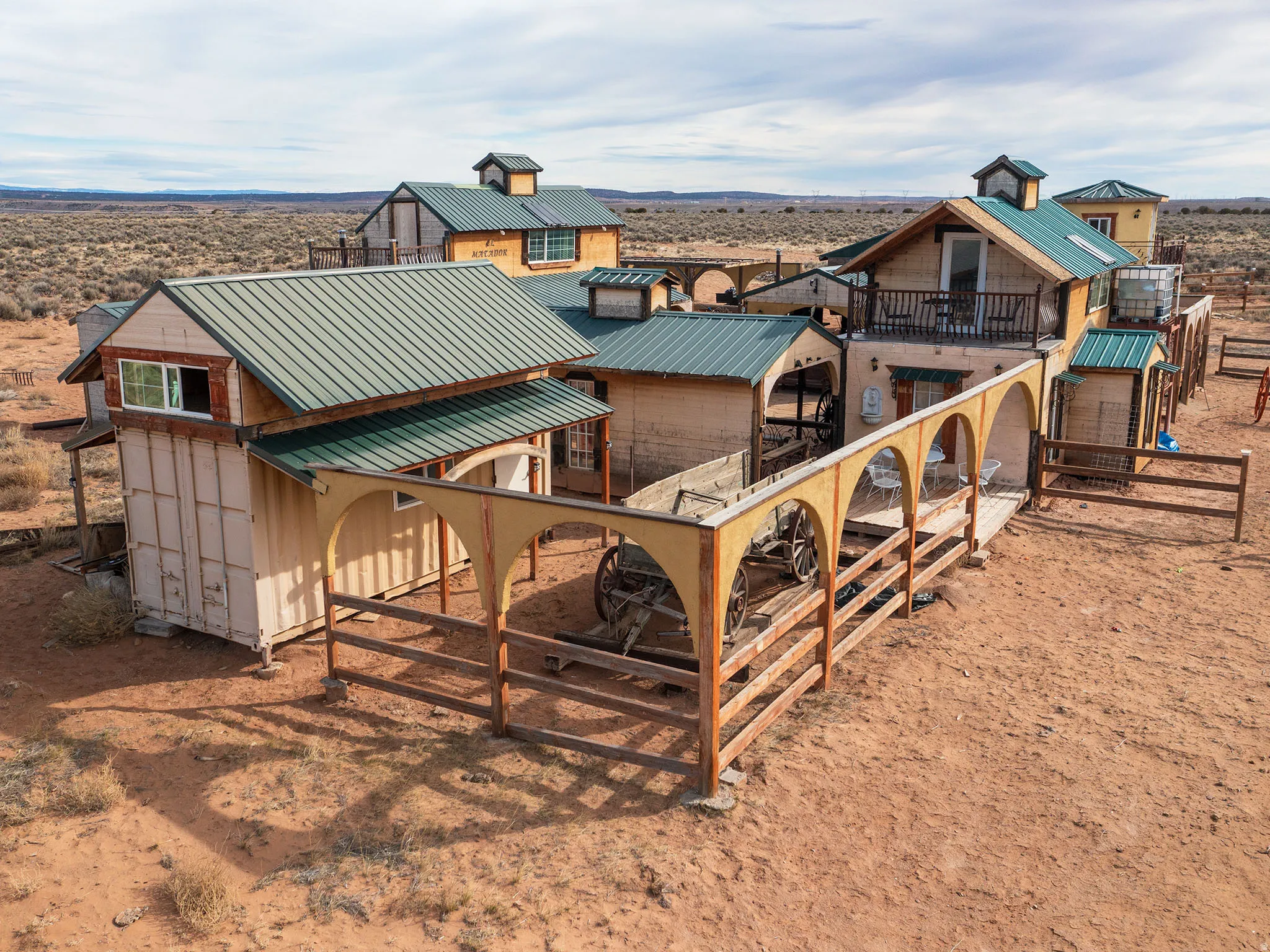 Rear view of house with a metal roof and a balcony