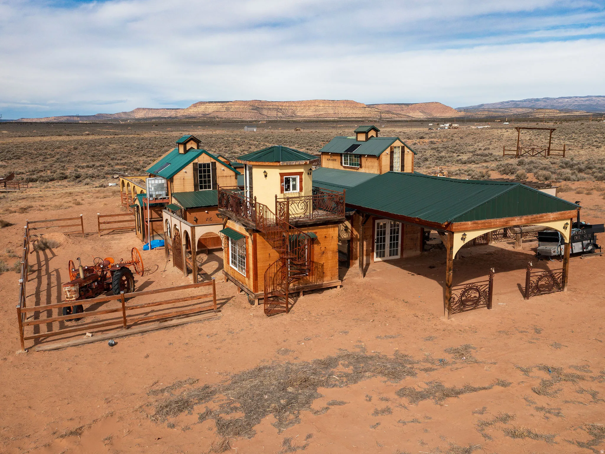 View of front of house featuring a metal roof, a patio area, a deck with mountain view, and a rural view