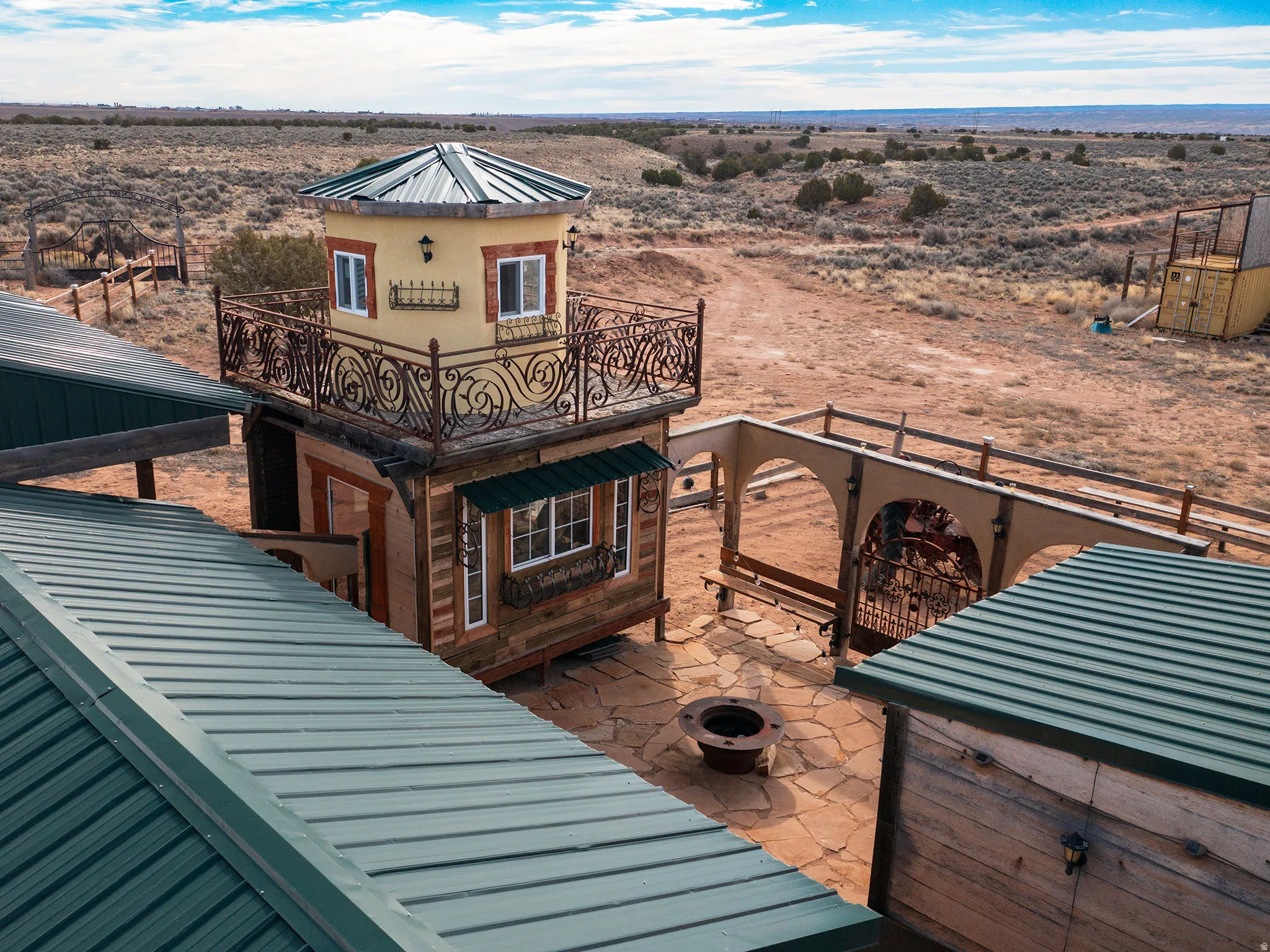 Exterior space featuring an outdoor fire pit, a view of countryside, and view of desert landscape